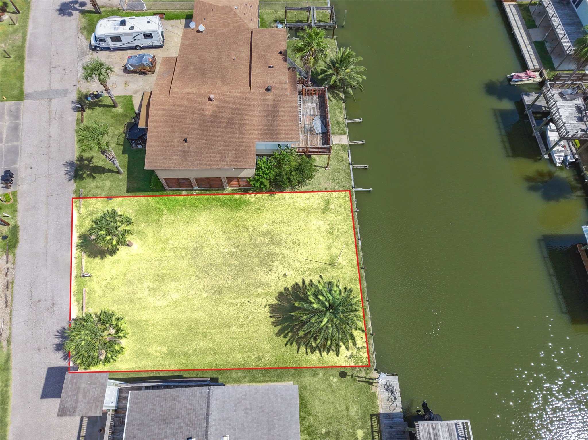 Straight down on the whole lot. A mature Canary Island date palm toward the water, two Sabal palms at the street, open grass between them, the canal on the right and Lakeside Drive on the left. Electric, gas, cable and phone are available, and water comes from Galveston County MUD 12, so the utilities are ready when you are! Straight down on the whole lot. A mature Canary Island date palm toward the water, two Sabal palms at the street, open grass between them, the canal on the right and Lakeside Drive on the left. Electric, gas, cable and phone are available, and water comes from Galveston County MUD 12, so the utilities are ready when you are!