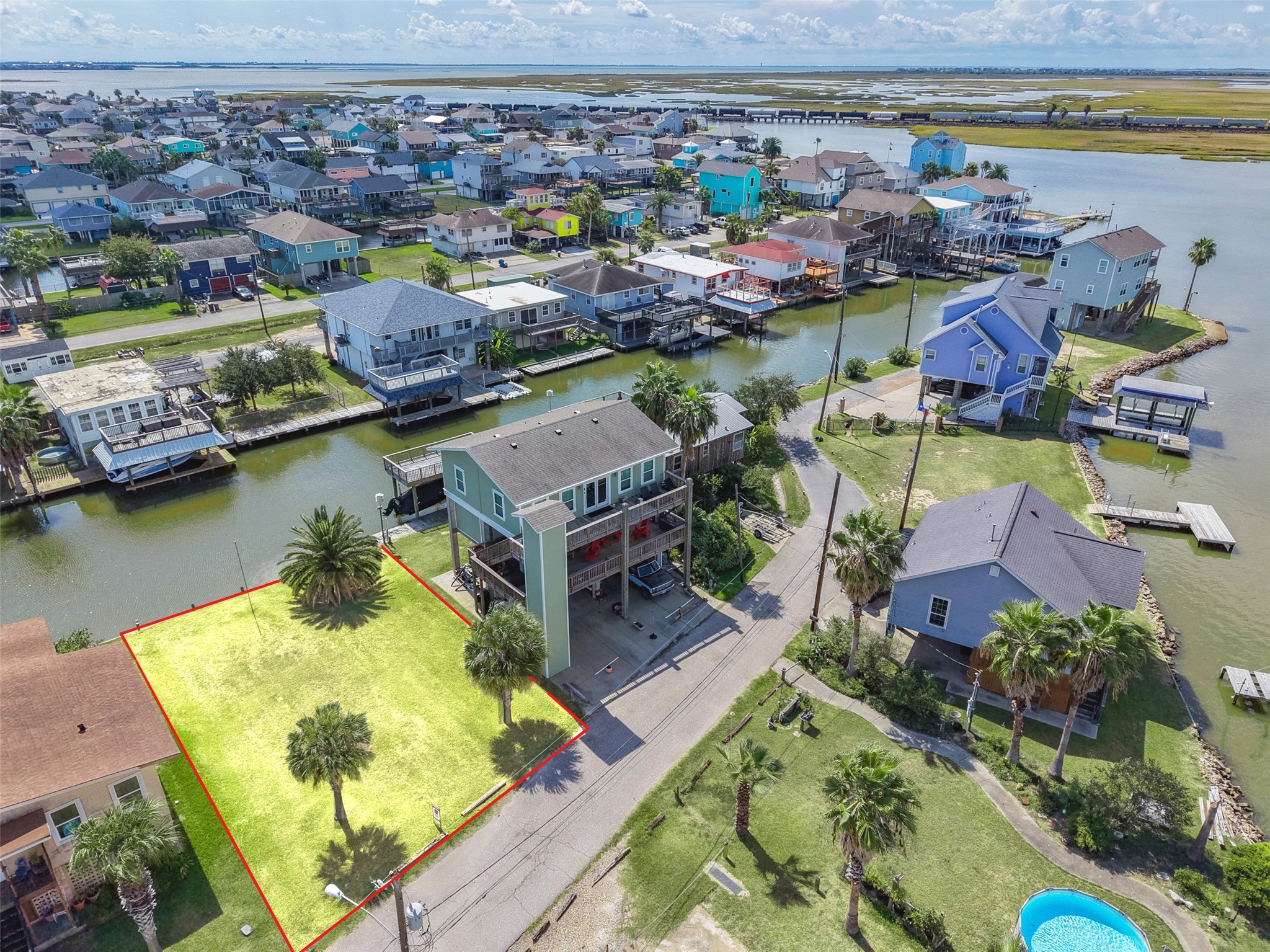 Street-side aerial with newer homes on both sides of the lot, so you would be building into an established stretch of lower Lakeside.