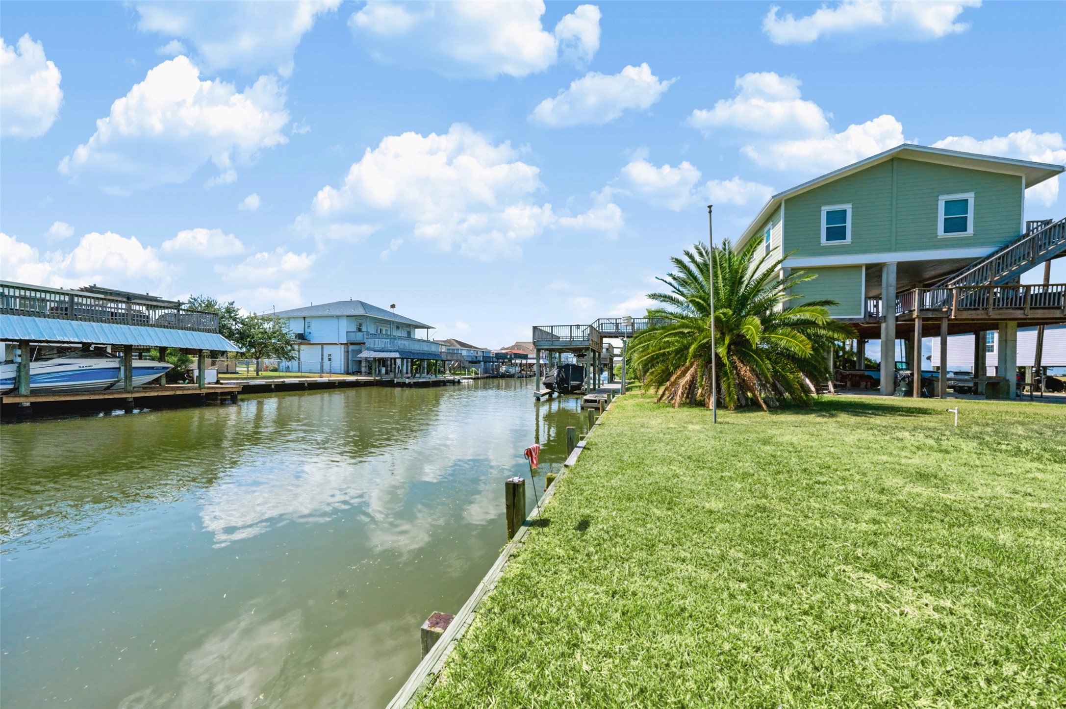 Standing at the bulkhead looking down the canal. Docks and homes line the far side, and the water runs out toward the bay. Launch from your own backyard and be fishing in minutes!
