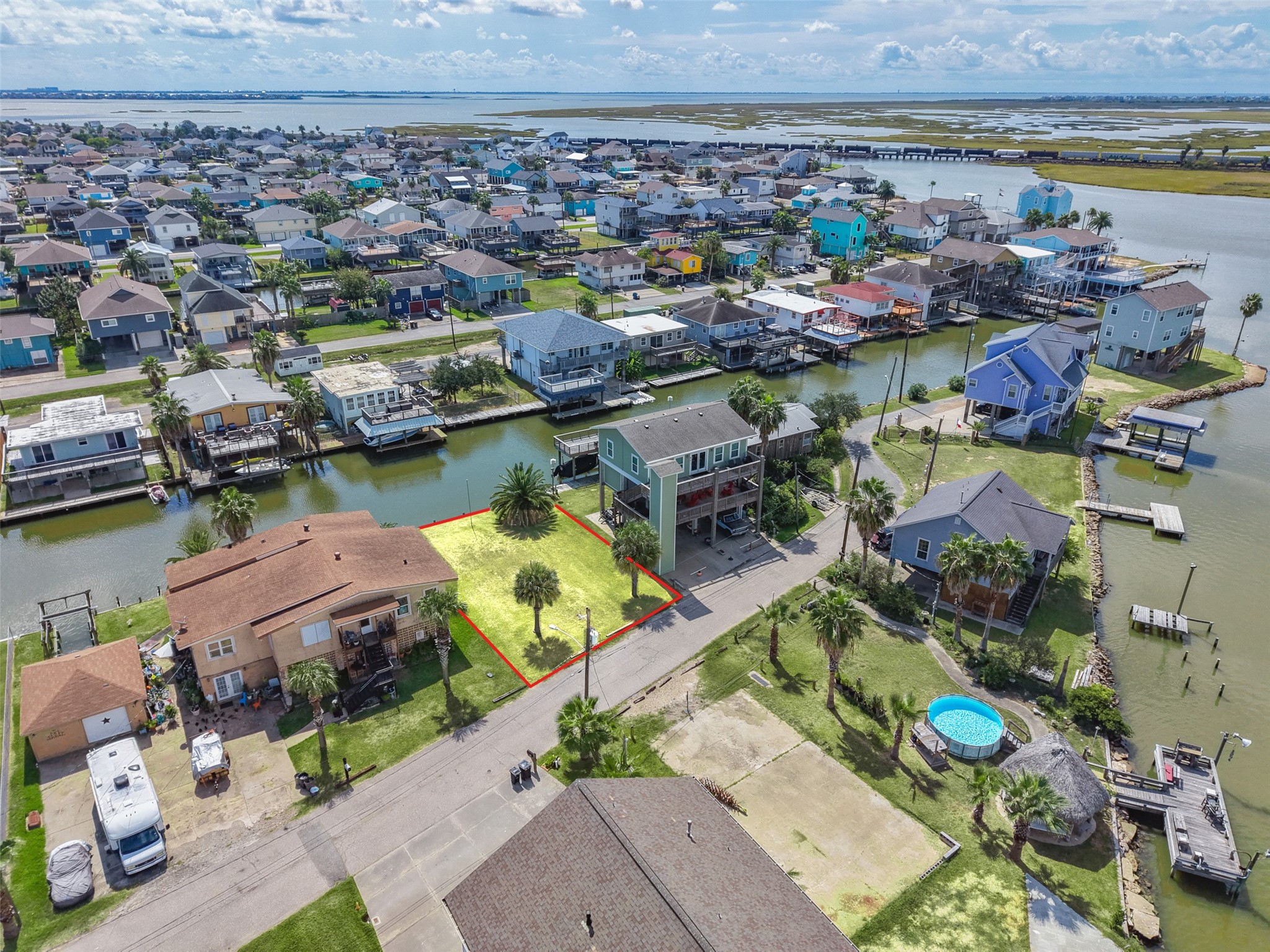 One step farther back. Lower Lakeside Drive is a mix of newer raised homes, docks and boat lifts, with the bay just past the last canal. Bayou Vista's city pool and park are about 0.8 miles away.