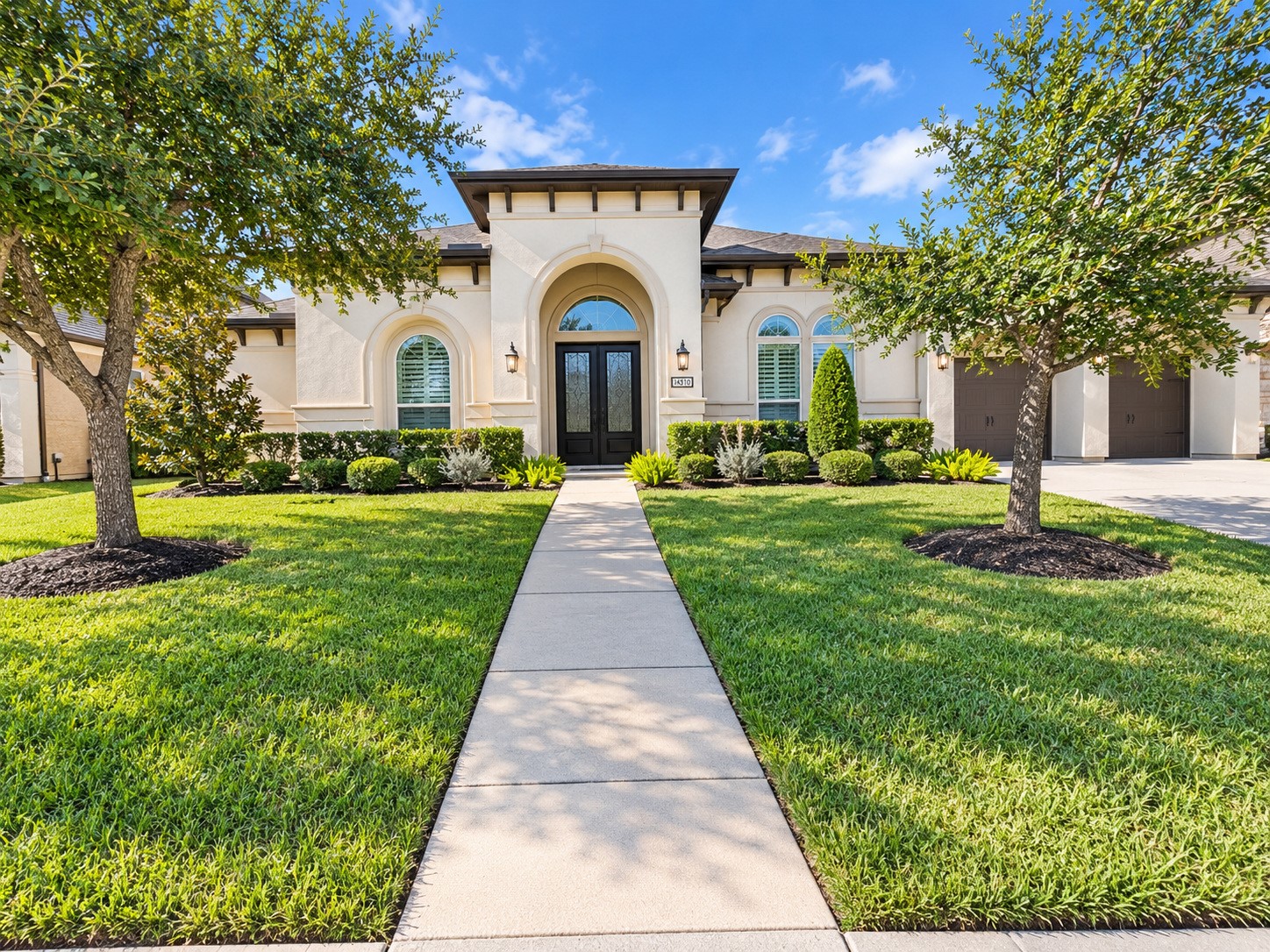 Welcome Home to 3414 Magnolia Shores! Impressive curb appeal featuring elegant stucco architecture, mature trees, and beautifully arranged landscaping.