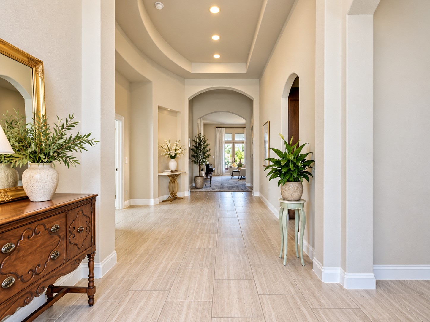 Spacious entry hall creates a welcoming first impression with soaring ceilings and timeless architectural details.