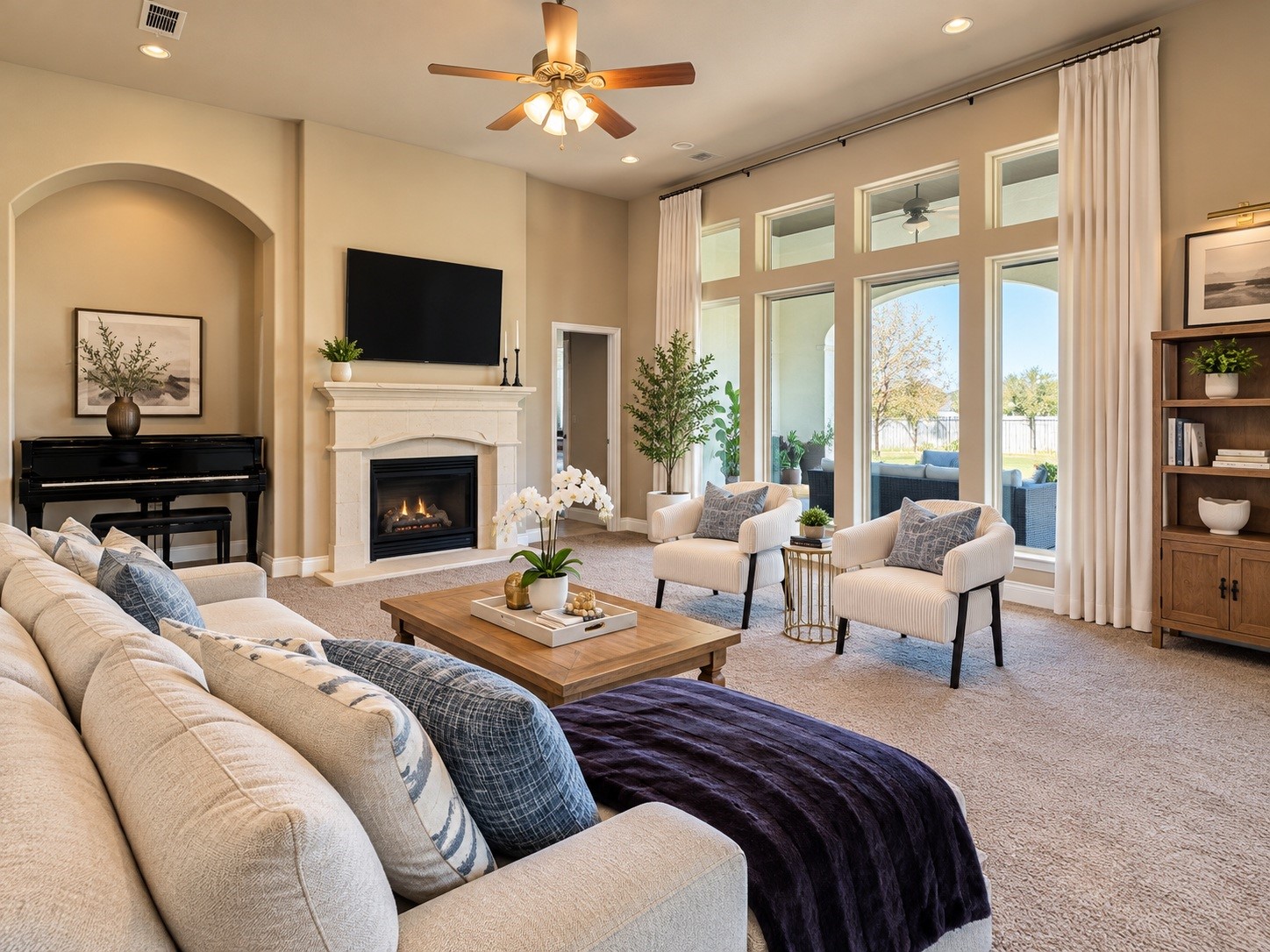 Spacious family room featuring generous seating space, large windows, and a warm, inviting atmosphere.