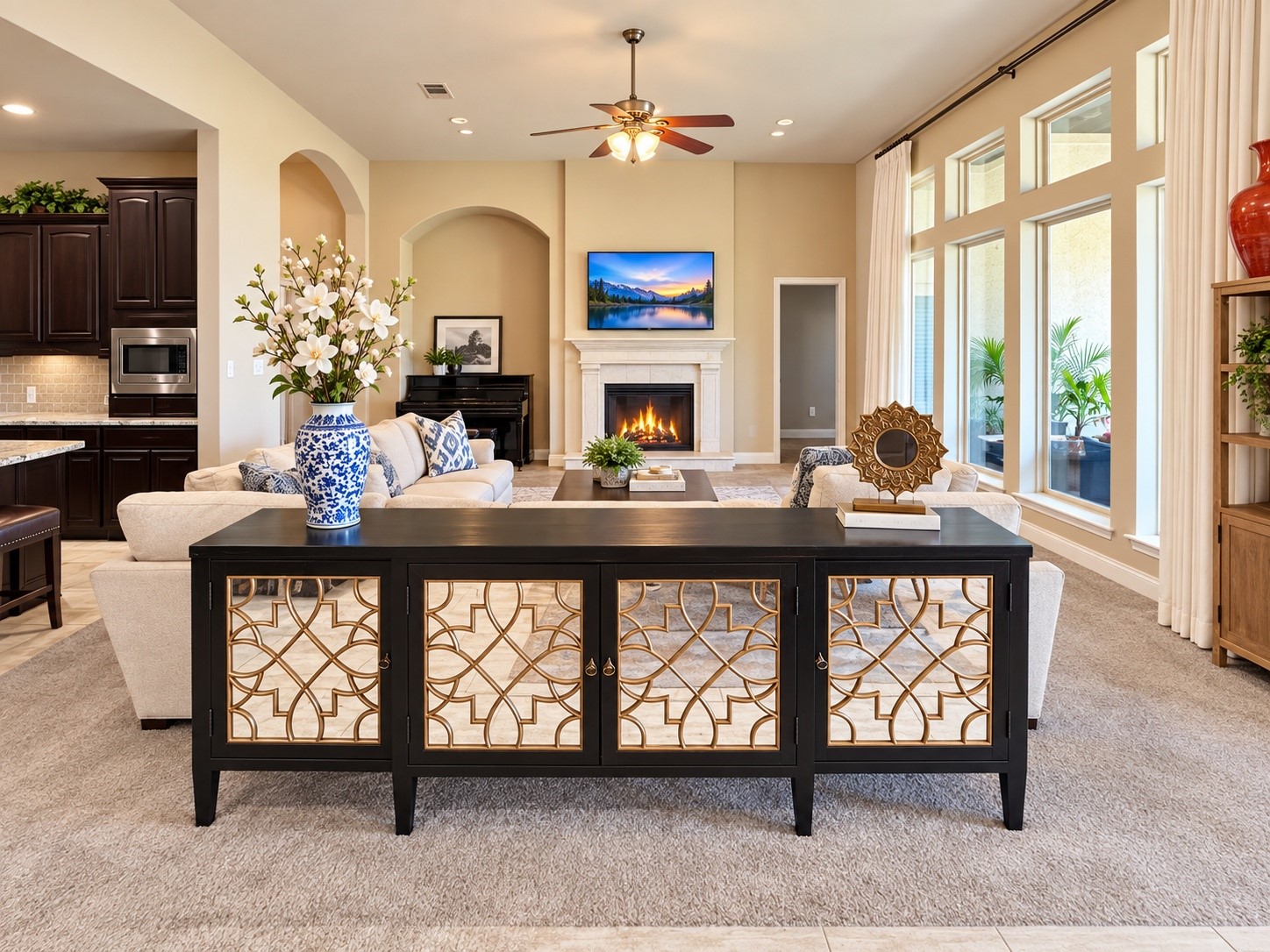 Bright, spacious family room with a welcoming fireplace and expansive windows overlooking the outdoor living area.