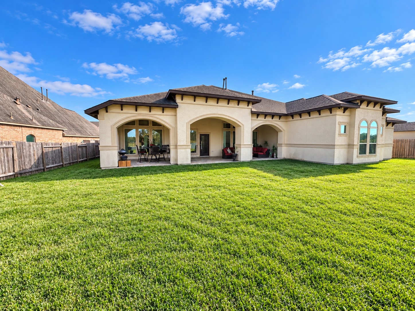 Spacious backyard with a covered patio, offering wonderful opportunities for outdoor entertaining.