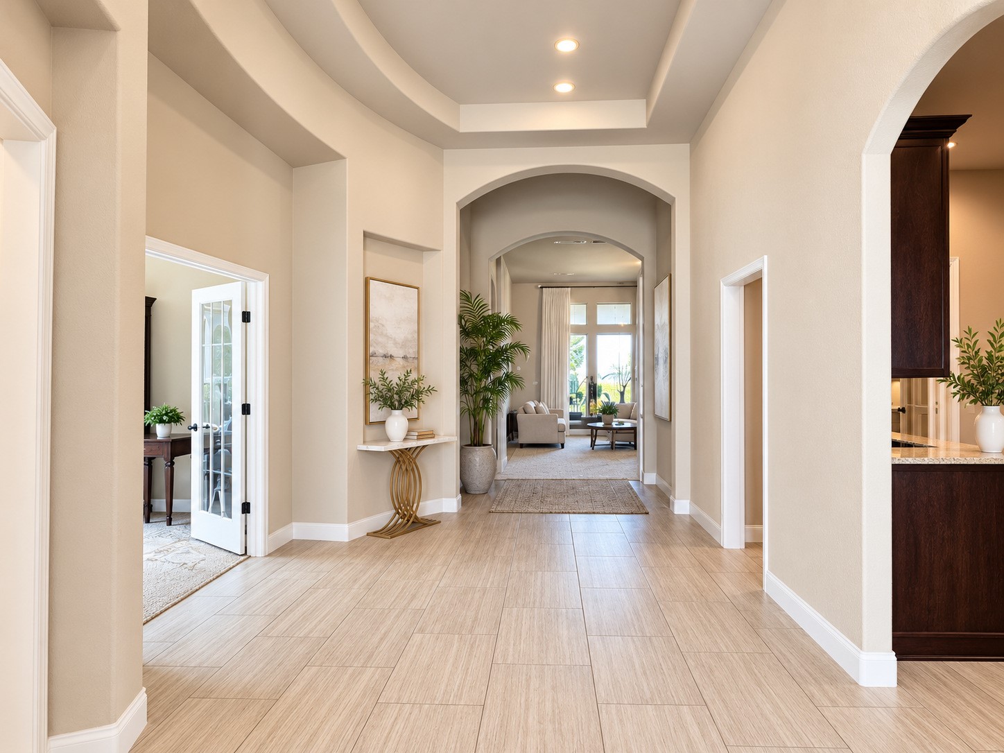 Elegant foyer showcasing graceful archways, a decorative ceiling design, and beautiful wood-look tile flooring.