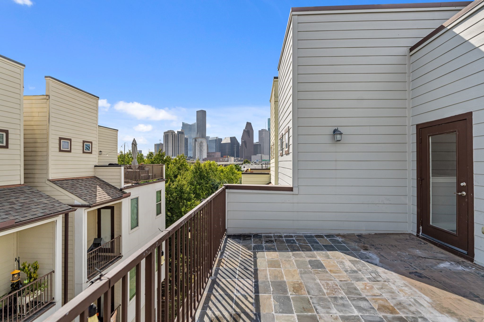 Fourth-floor terrace with views of the Downtown Houston skyline, offering an outdoor space for relaxing or entertaining.