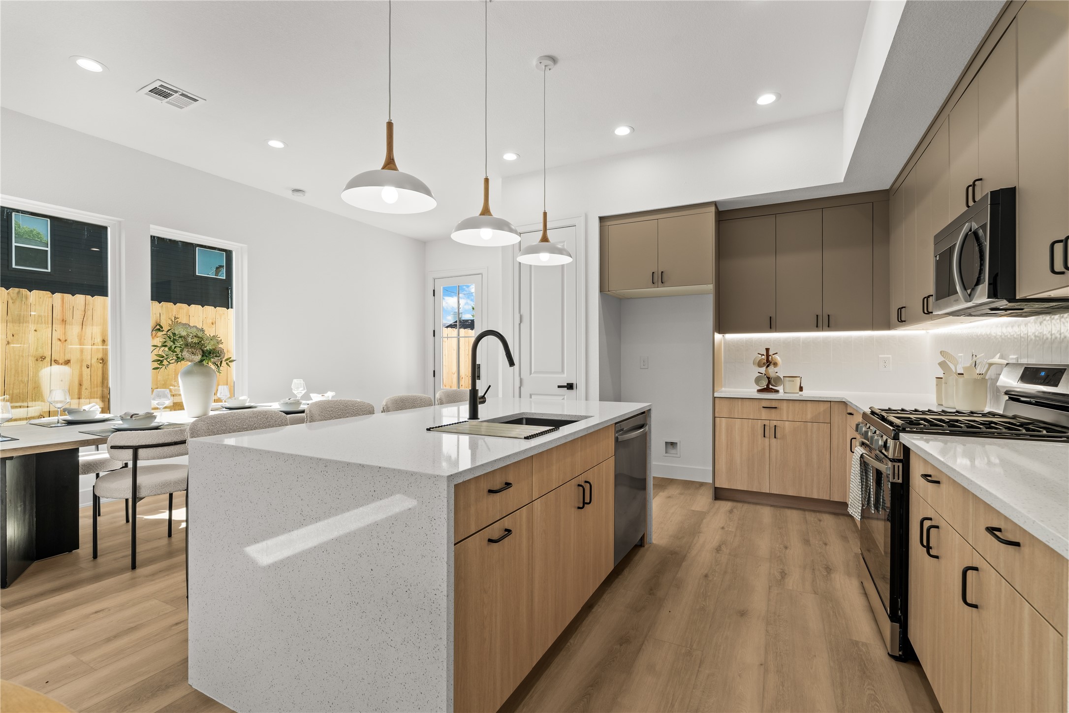 The large kitchen island anchors the room and features a breakfast bar that leads into a separate dining area.