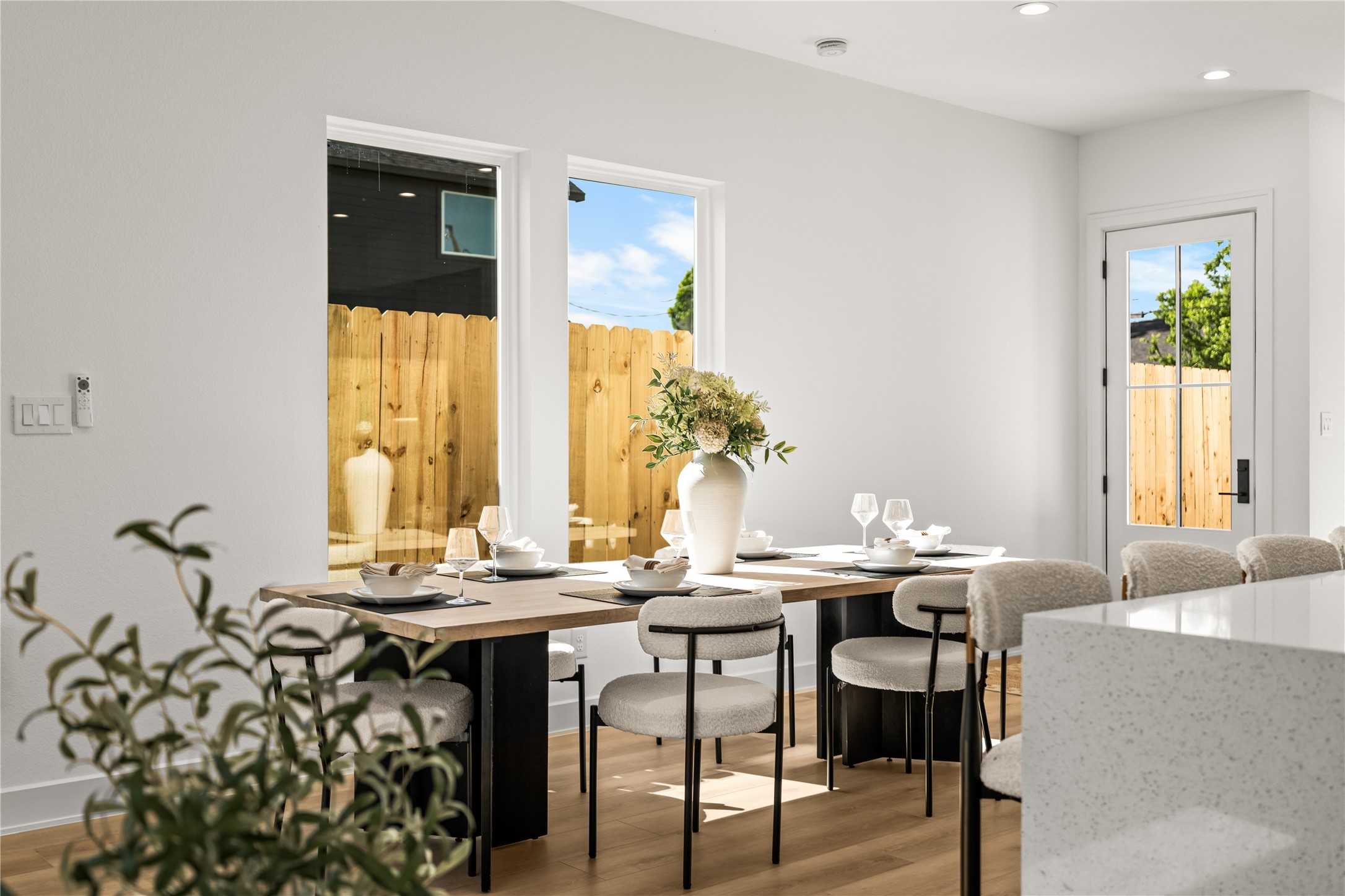 This bright dining area perfectly situatued between two large windows.
