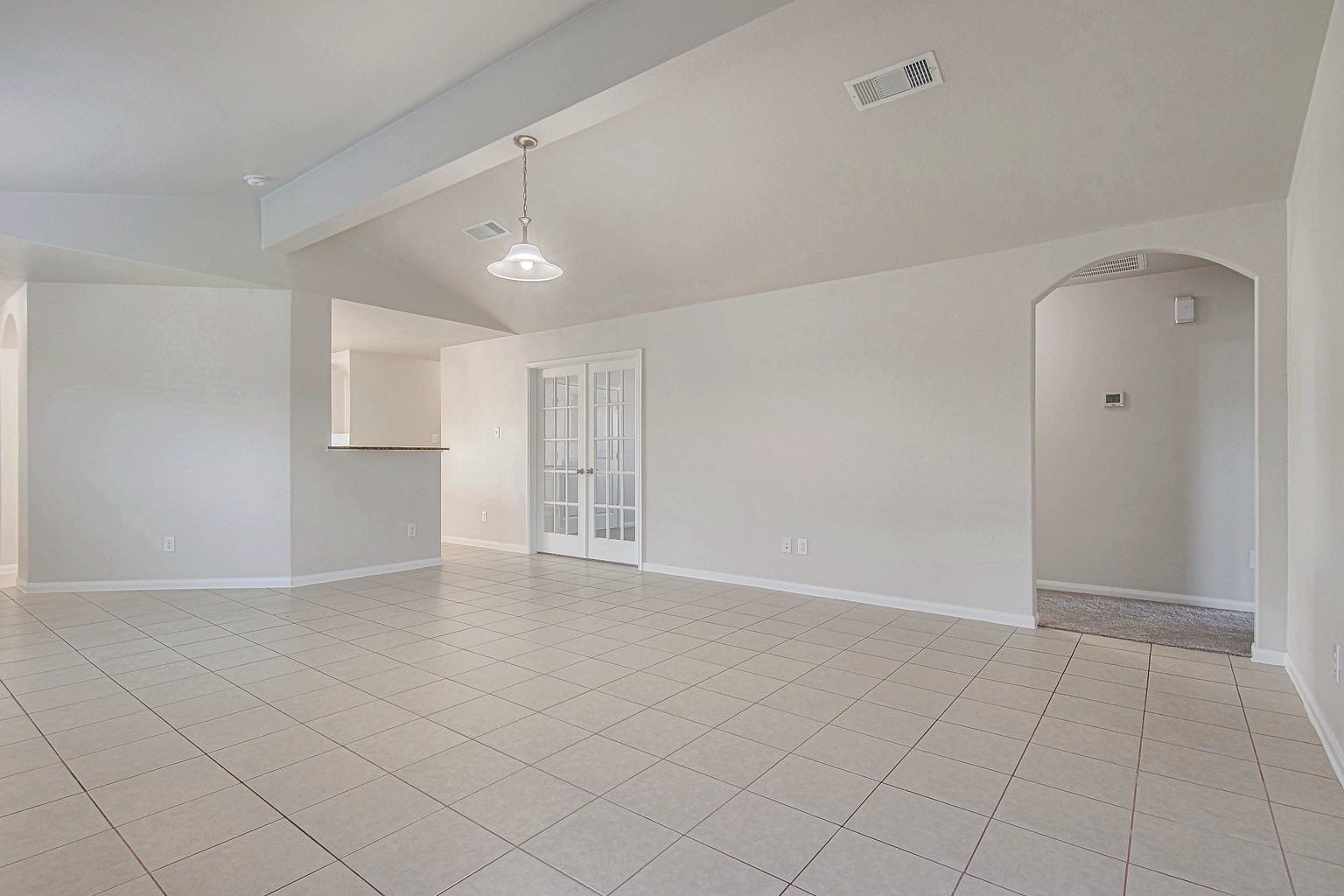 Another view of the living room showcases its open layout and connection to the kitchen and adjoining spacesideal for gathering and entertaining.