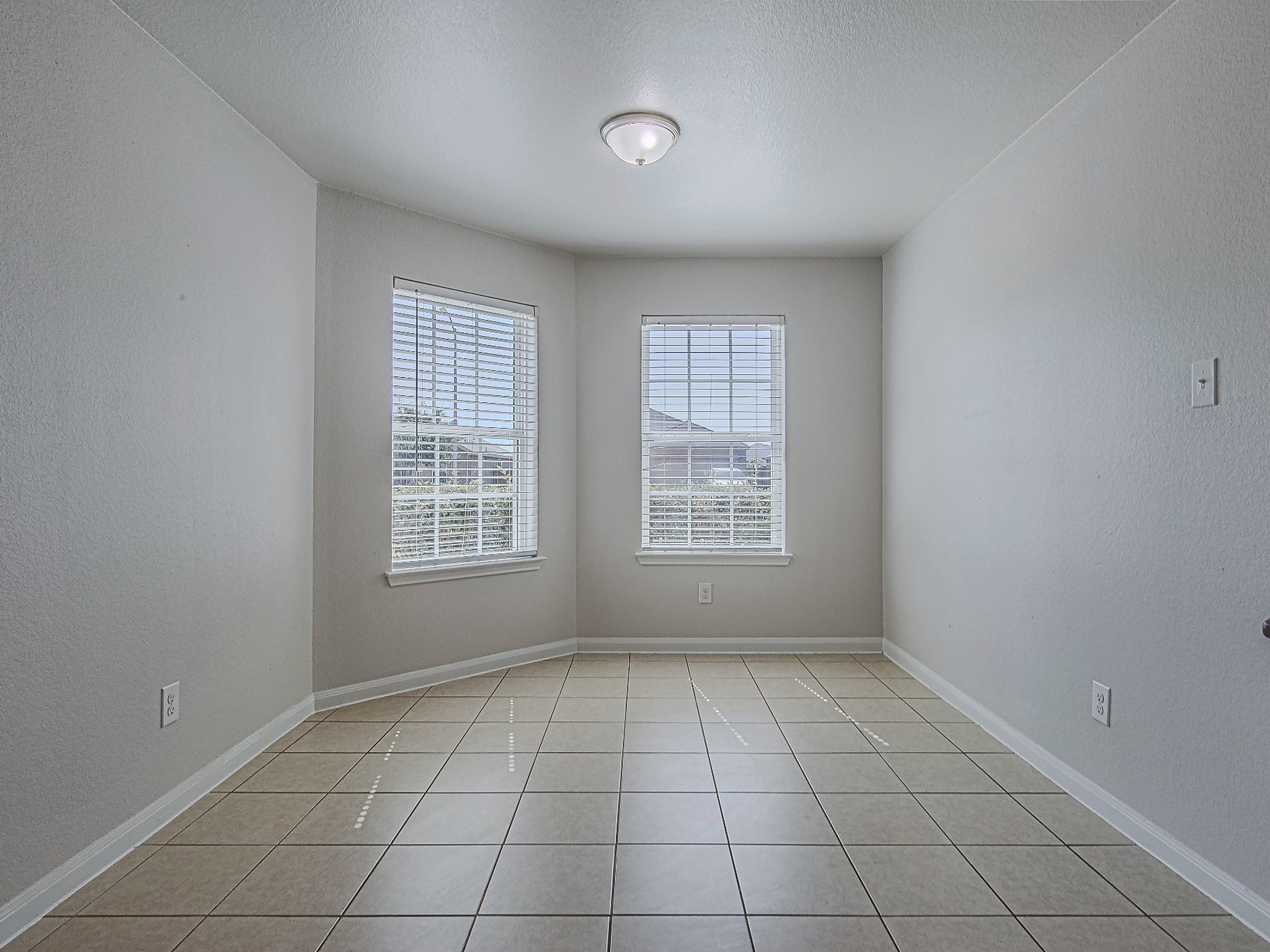 Two windows fill the dining nook with natural light, creating a welcoming spot for morning coffee and everyday meals.