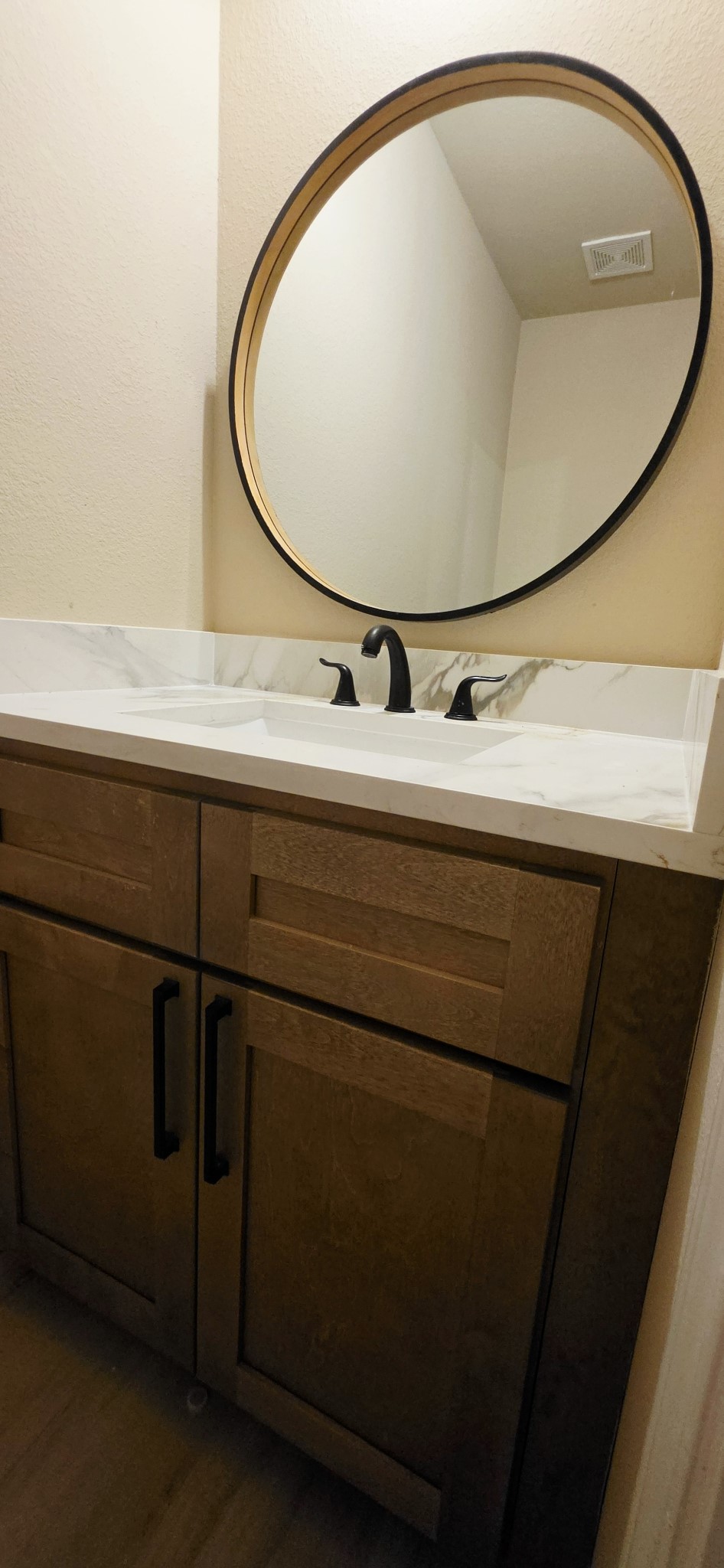 Half bathroom for your guests, features all wood cabinets