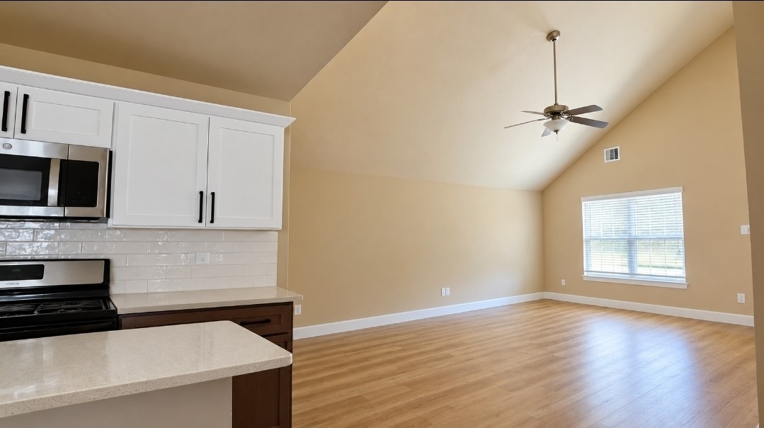 View of the living area from the kitchen features lots of natural light