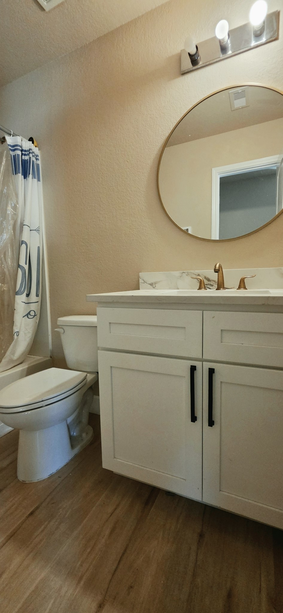 Upstairs full bathroom feature shower and tub combination and all wood cabinets