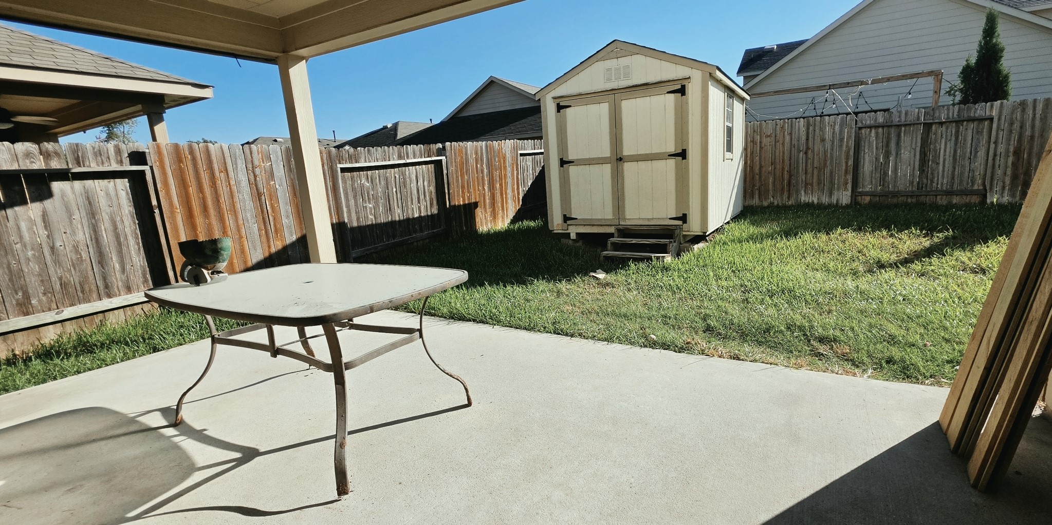 Storage shed in the back yard and covered back porch