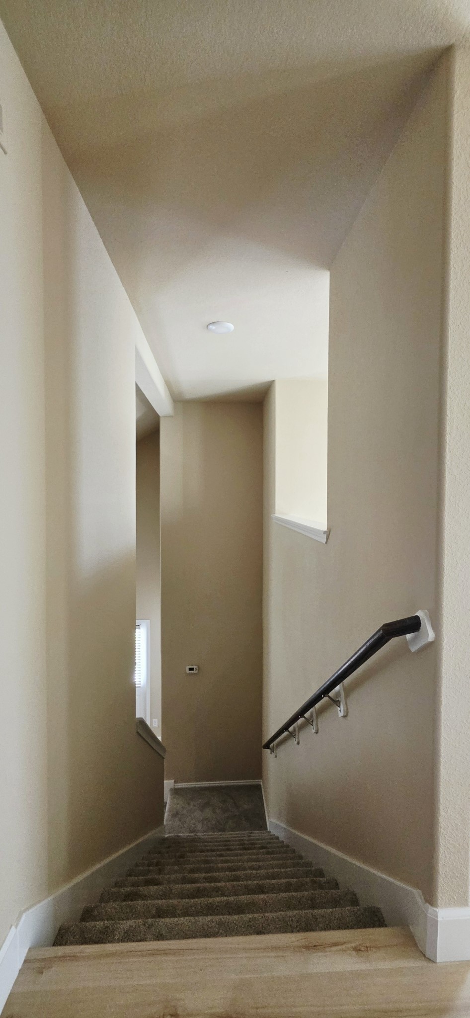View of the stairs and opening in the game room.