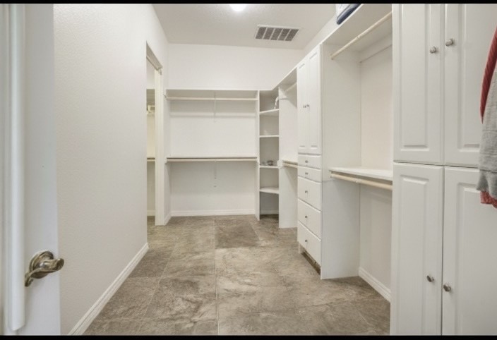 It takes two photos to see the entire primary closet.