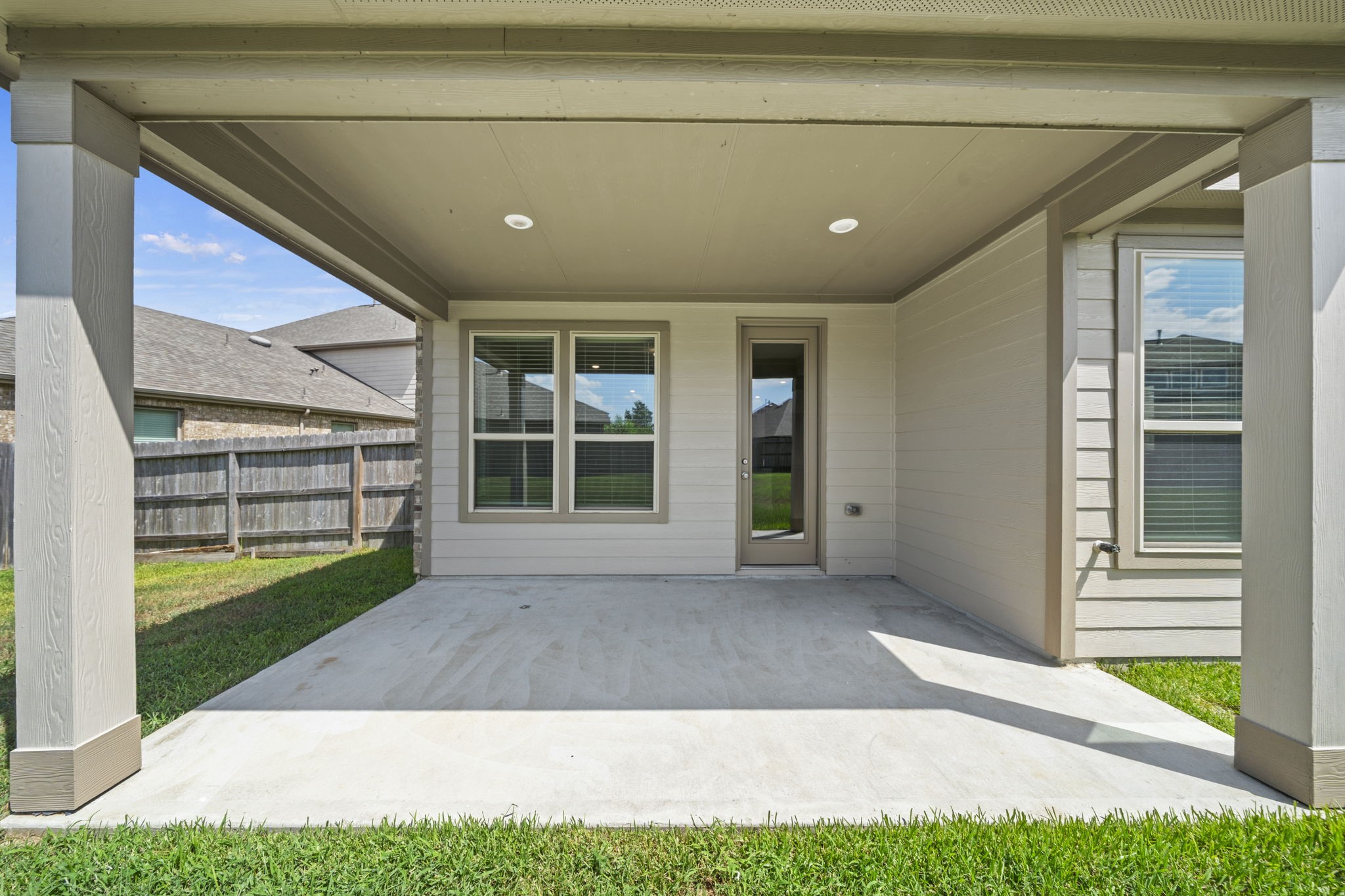 Relax or entertain on this spacious covered back patio that offers seamless indoor-outdoor flow into your private backyard.