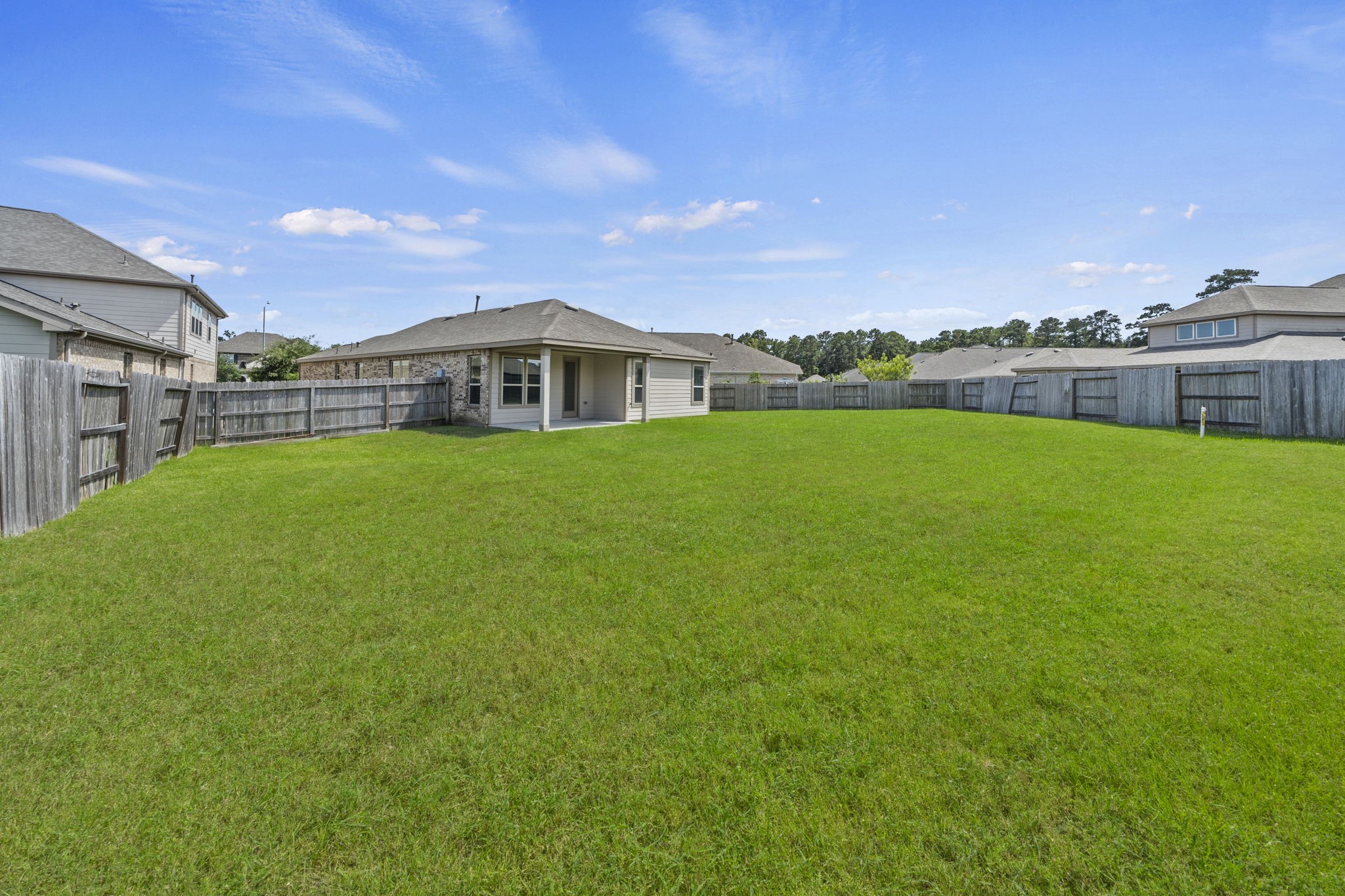 Expansive, fully fenced backyard offering endless space for pets, play, or adding a future pool.