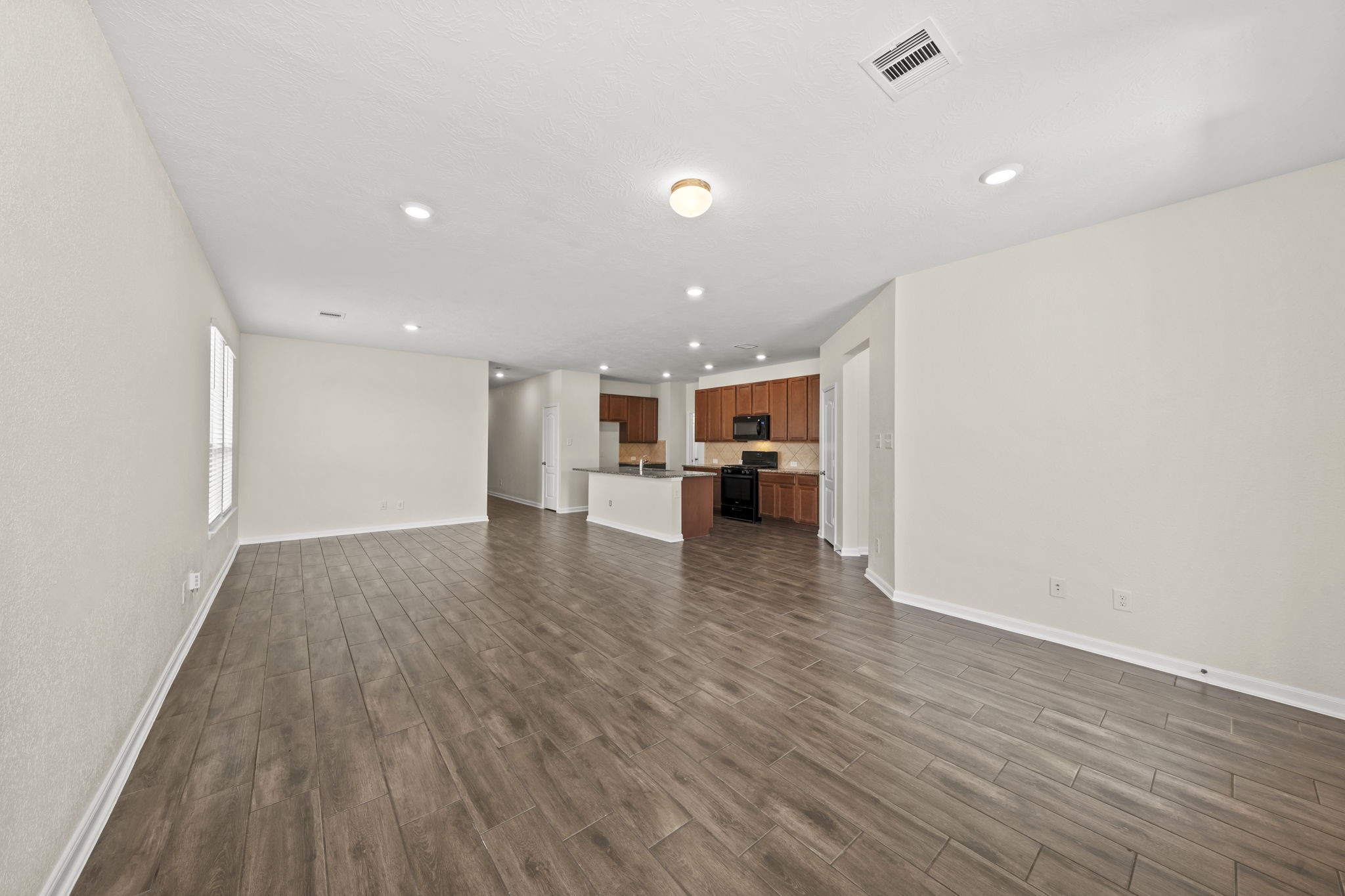 Offers an open and airy feel with a seamless flow directly into the adjoining kitchen.