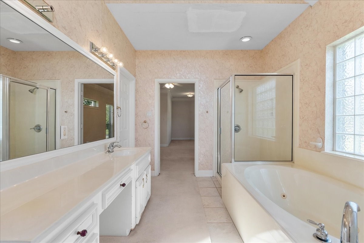 A deep jetted soaking tub provides an indulgent spot to decompress after long days.