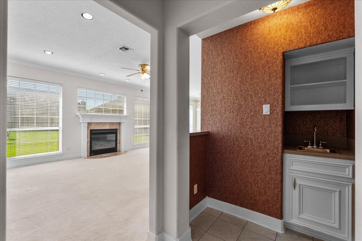Conveniently situated just steps from the living room, this dedicated wet bar with built-in cabinetry and a bar sink makes entertaining seamless.