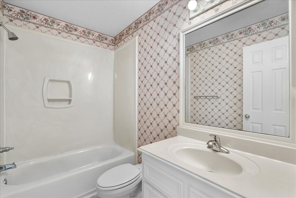 Ample vanity counter space flanking the sink gives guests plenty of room for toiletries