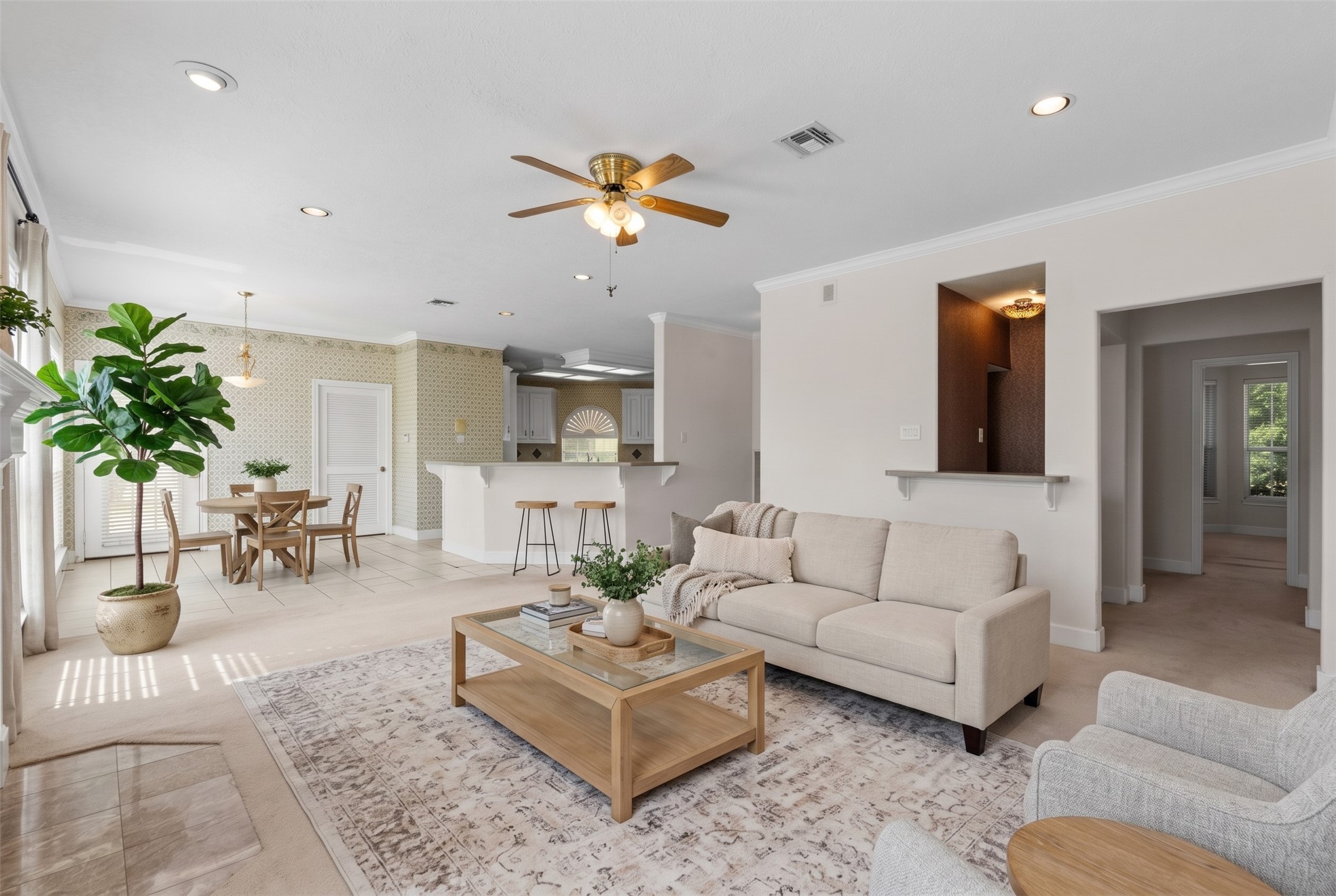 The open-concept layout connects directly into the breakfast nook and raised bar.