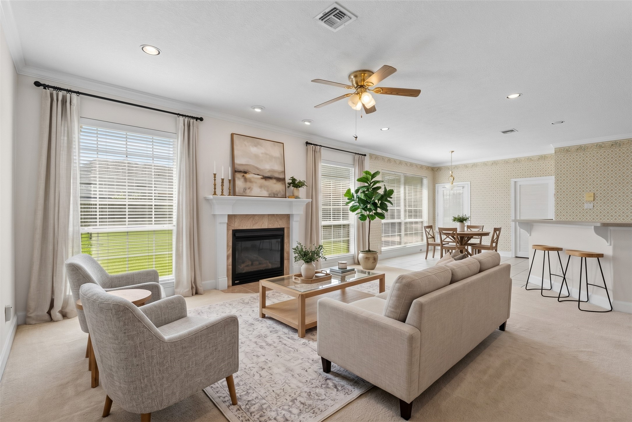 Generous natural light pours through a wall of oversized windows, making this expansive 17x21 living room feel bright and inviting throughout the day.