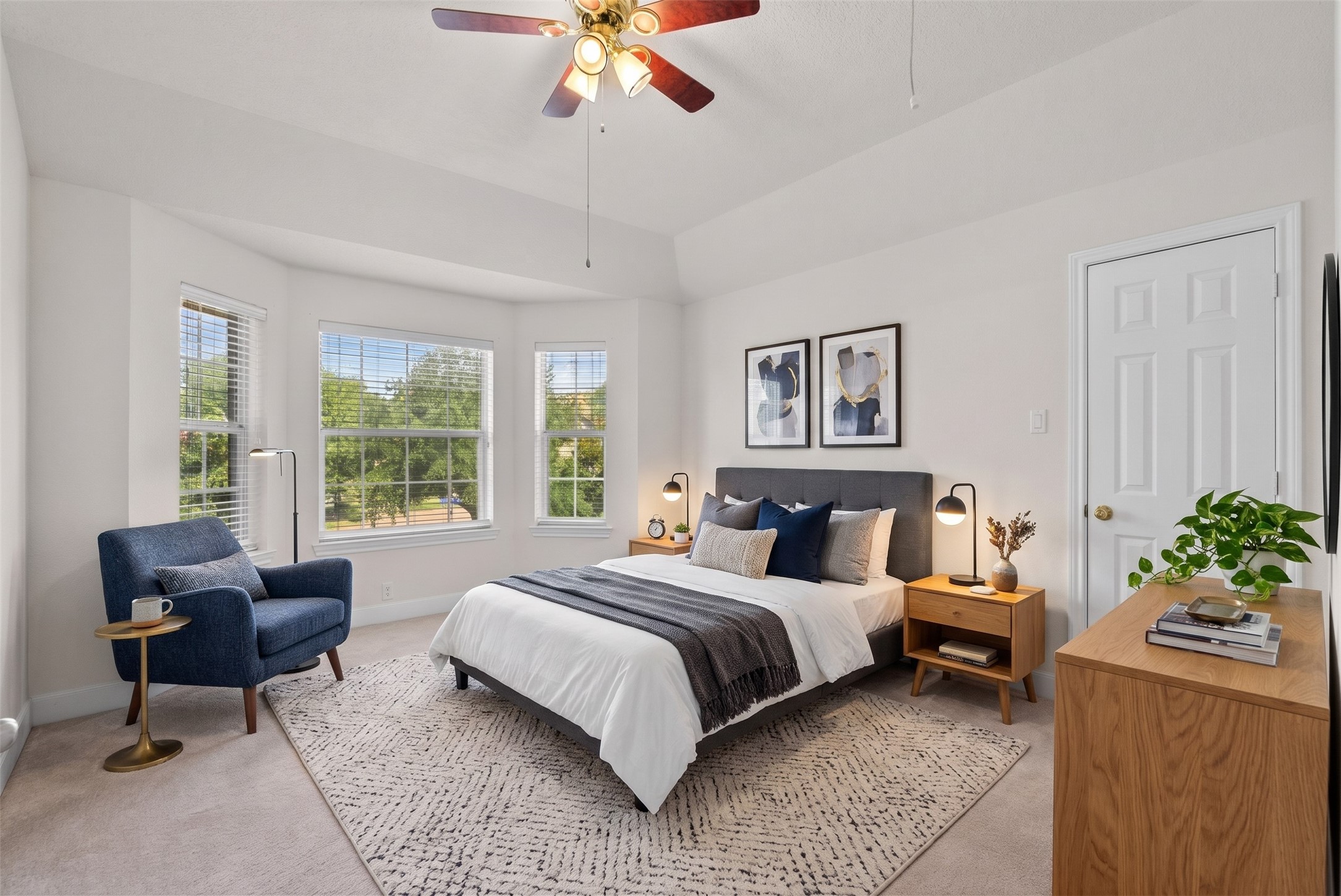 A handsome bay alcove with three large windows channels abundant natural light deep into the room.