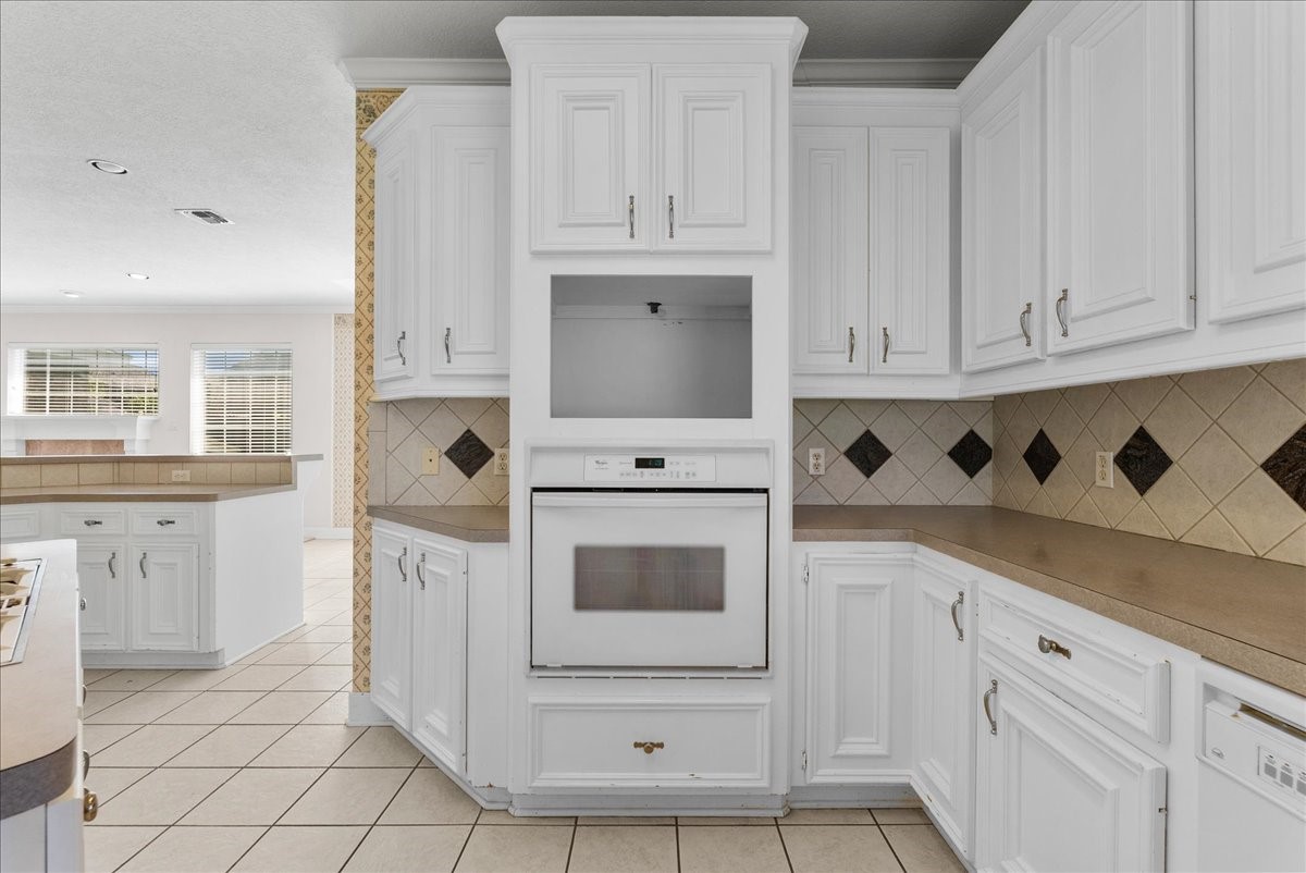 Stacking the built-in oven and dedicated microwave alcove vertically frees up valuable counter space.