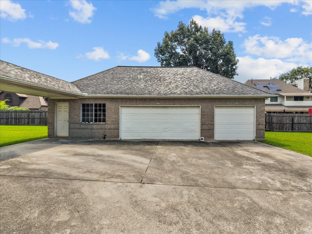 Oversized detached 3-car garage featuring a covered breezeway connection.
