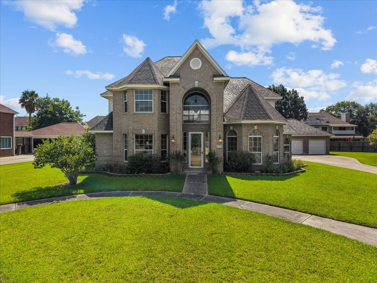 Nestled on an oversized corner lot in Baytown's established Country Club Oaks