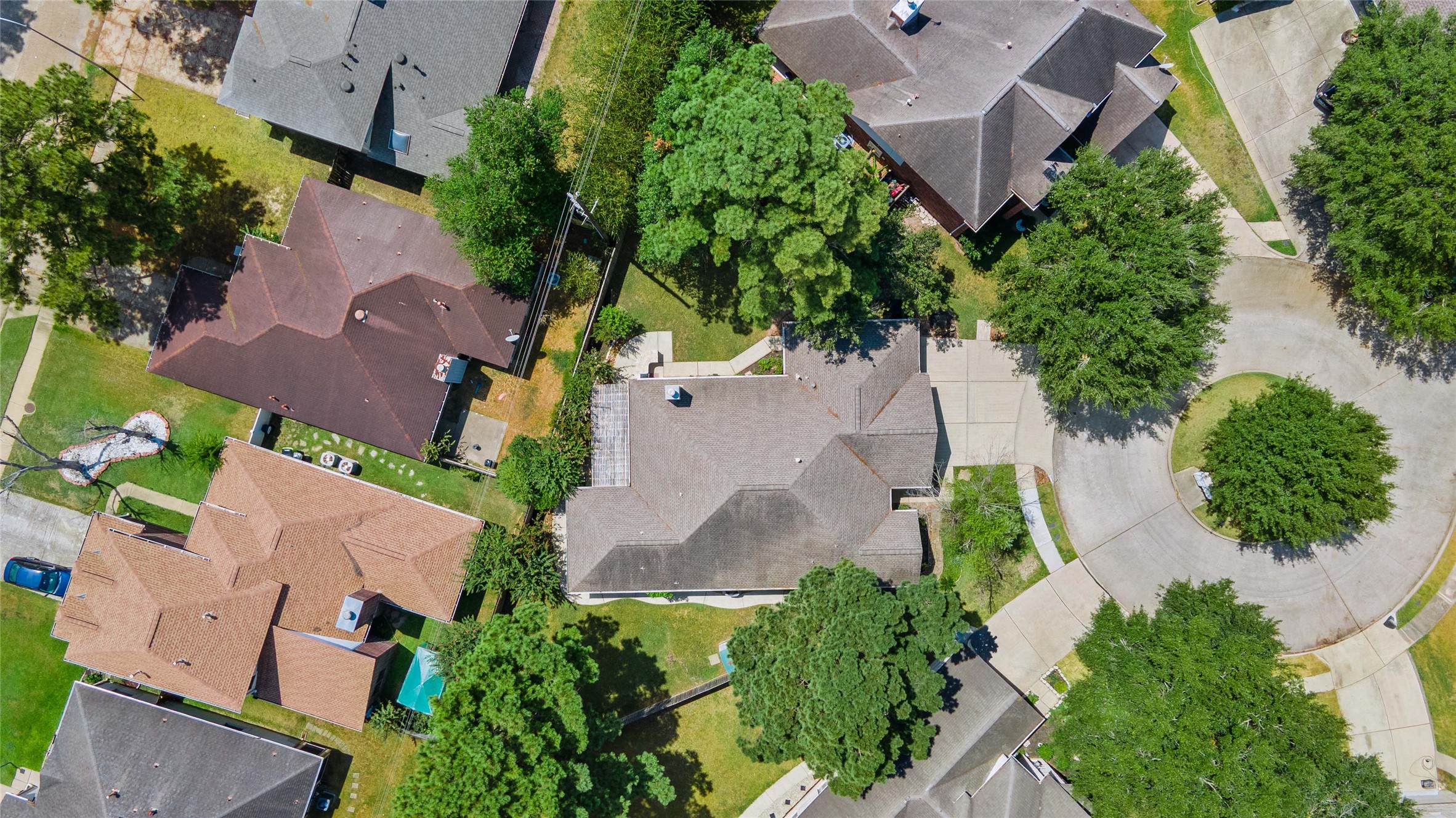 Your new home is in the center of this photo which shows the house flanked by trees on both fence lines and the cul-de-sac on the right.