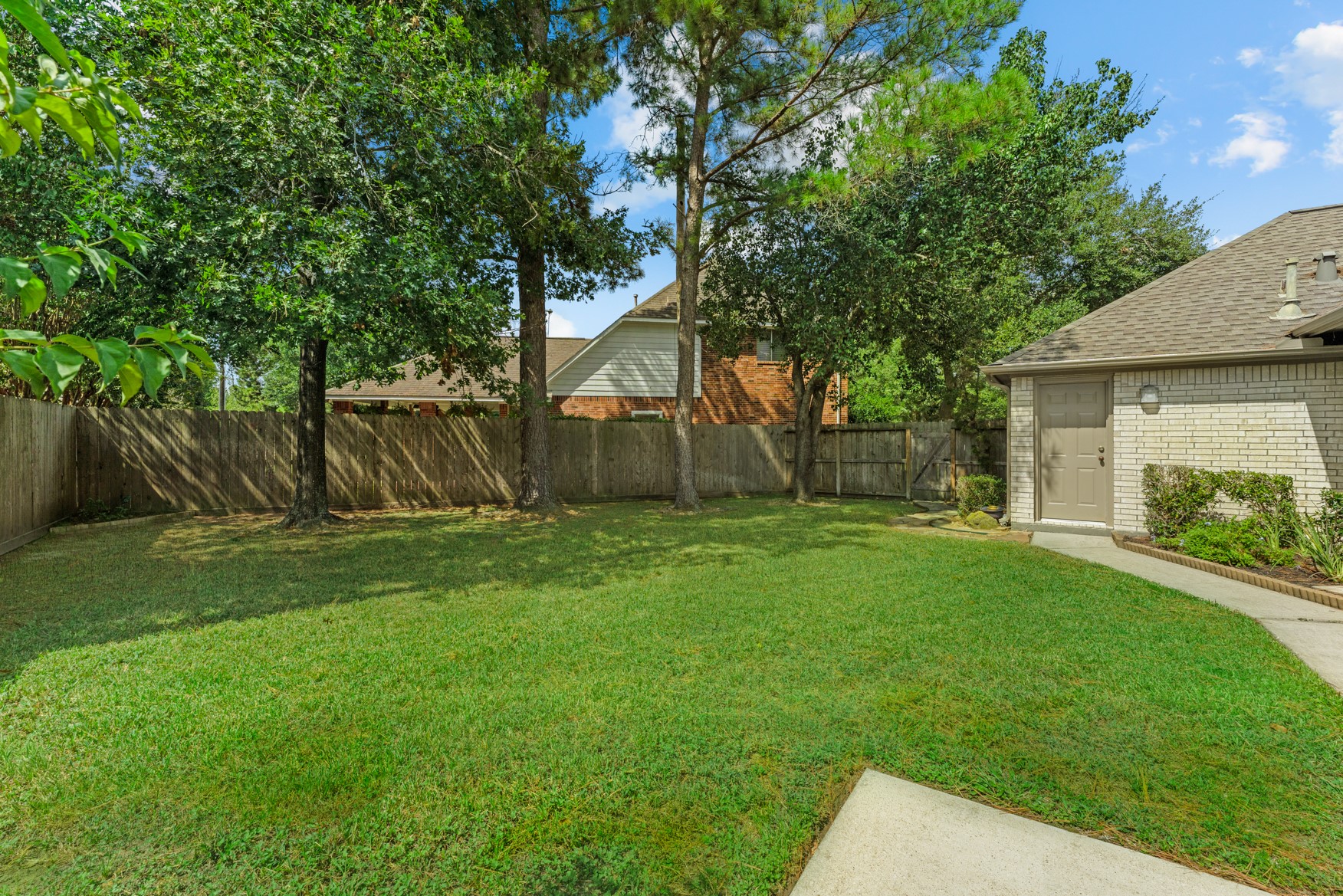 One of TWO huge lawn areas in your backyard!  The door on the right leads to the garage.