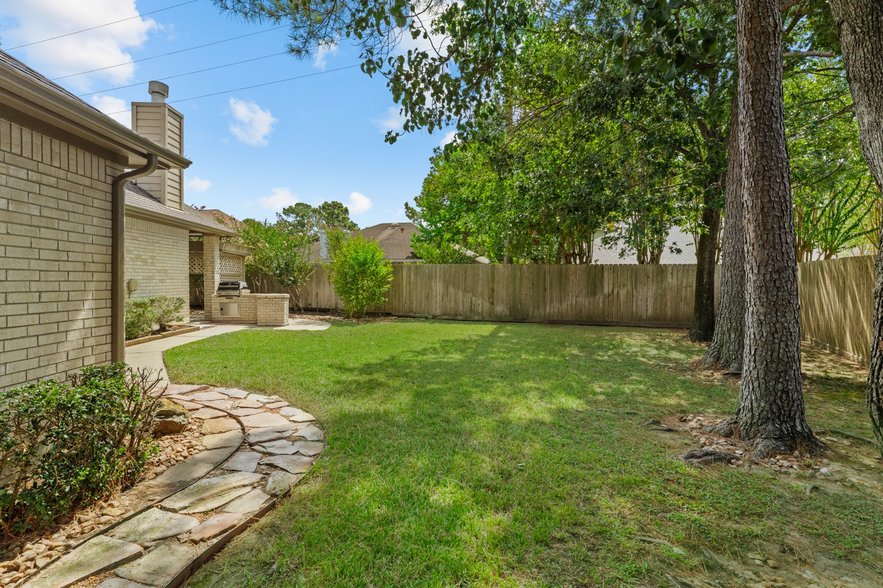 Stone pathways and neat edging add to the charm of this property.