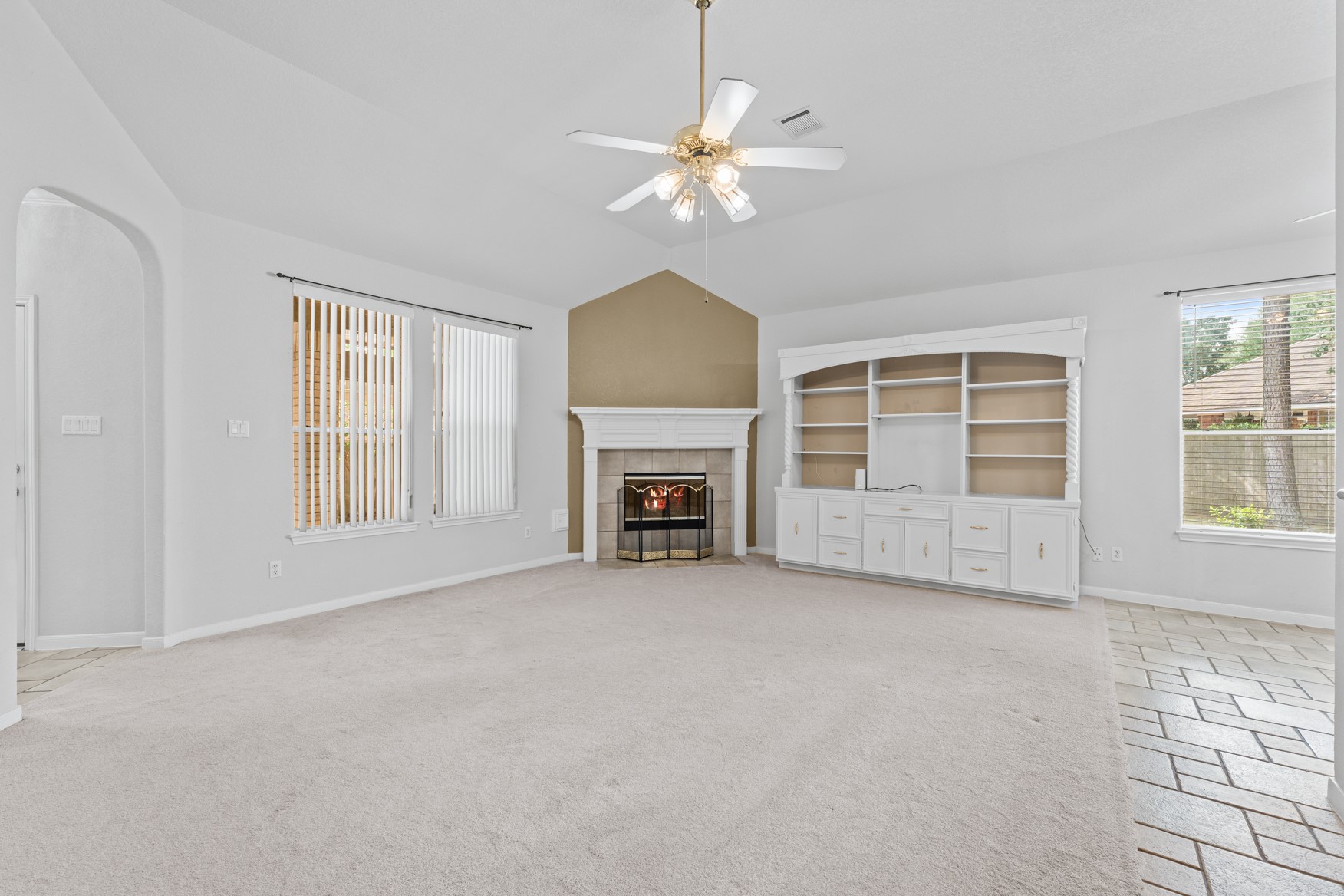 Your living room offers a view to the back patio and includes a gas fireplace for chilly evenings, high ceilings, and is open to the other common areas of the house.