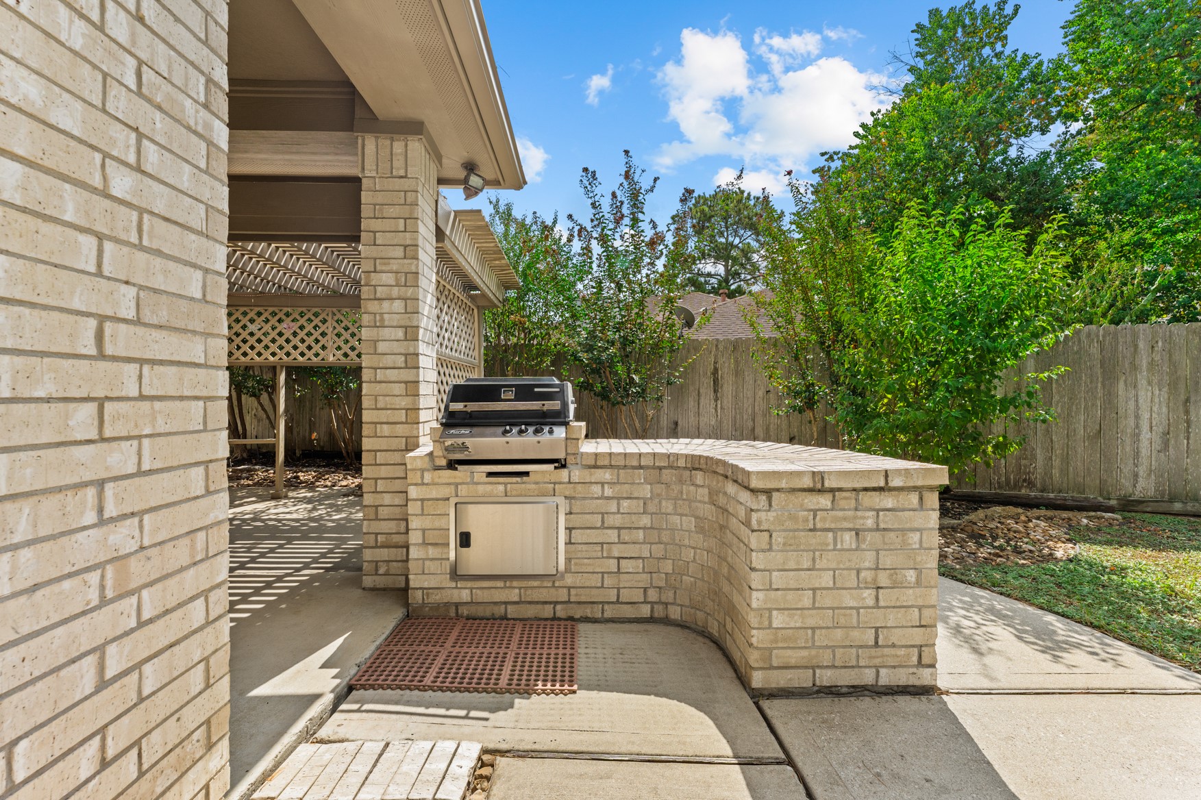 Enjoy grilling your favorites using this outdoor grill area with an extended brick counter top.