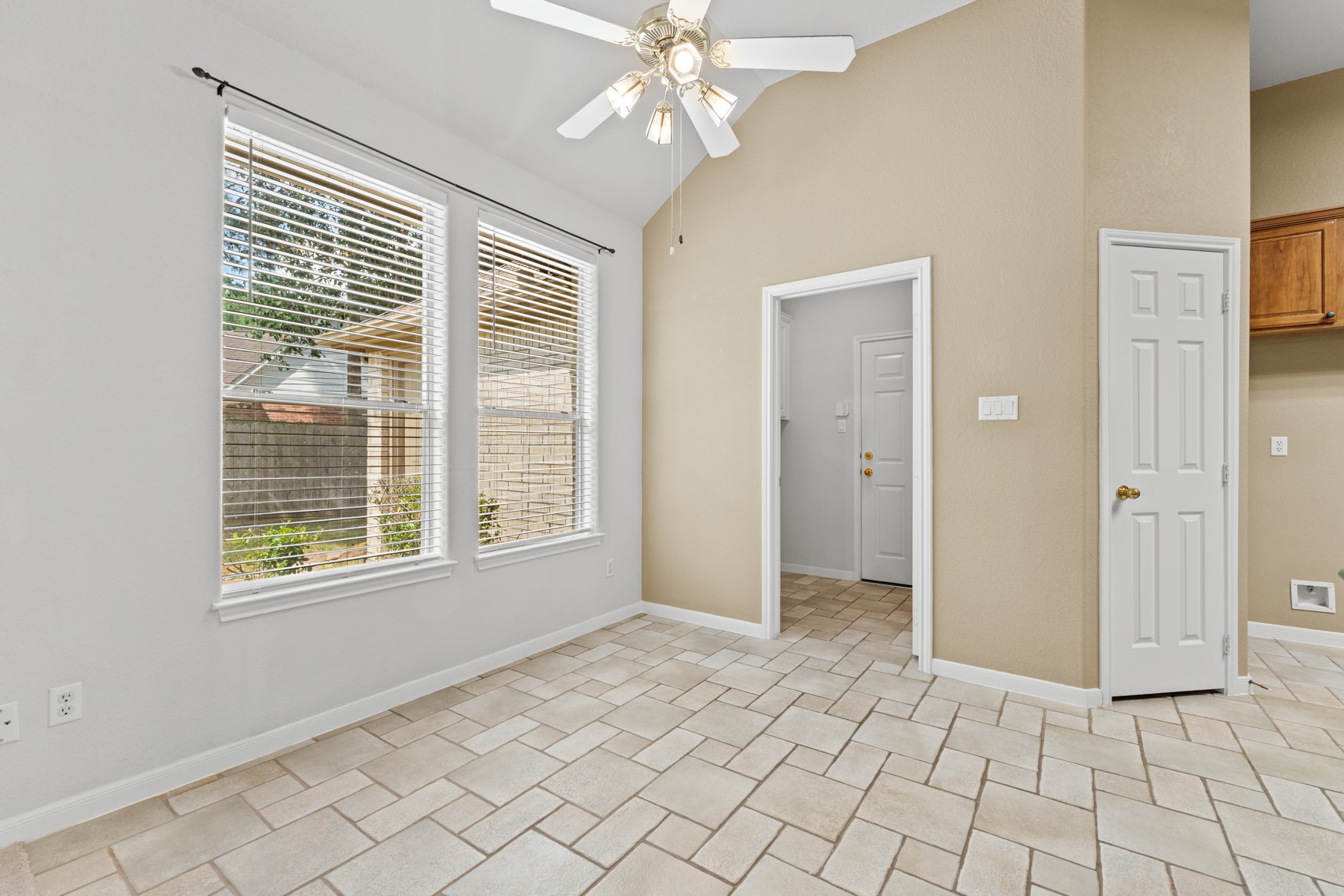 Enjoy meals in this cheery, sunny breakfast area with a view of the huge yard. The doorway in the center leads to the laundry room and 3-car garage.