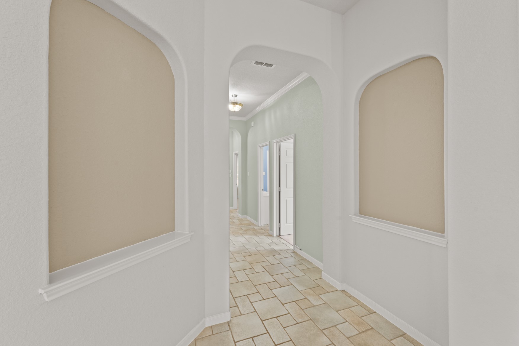Art niches and and arched pass-throughs give this home architectural interest!