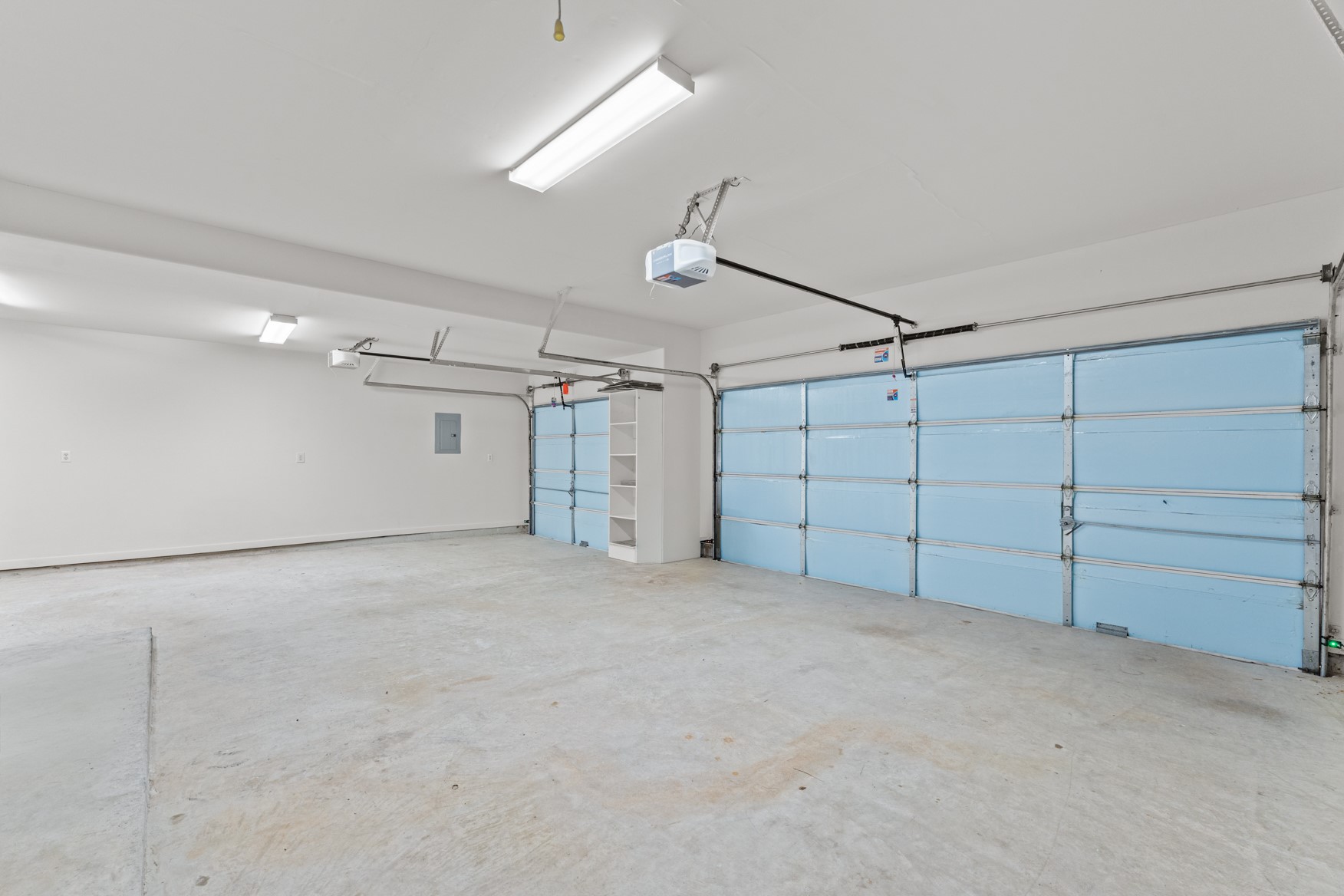 Welcome to your spacious 3-CAR GARAGE! This space is well-lit so it would be easy to use a portion of it for a workshop, gym area, and more!