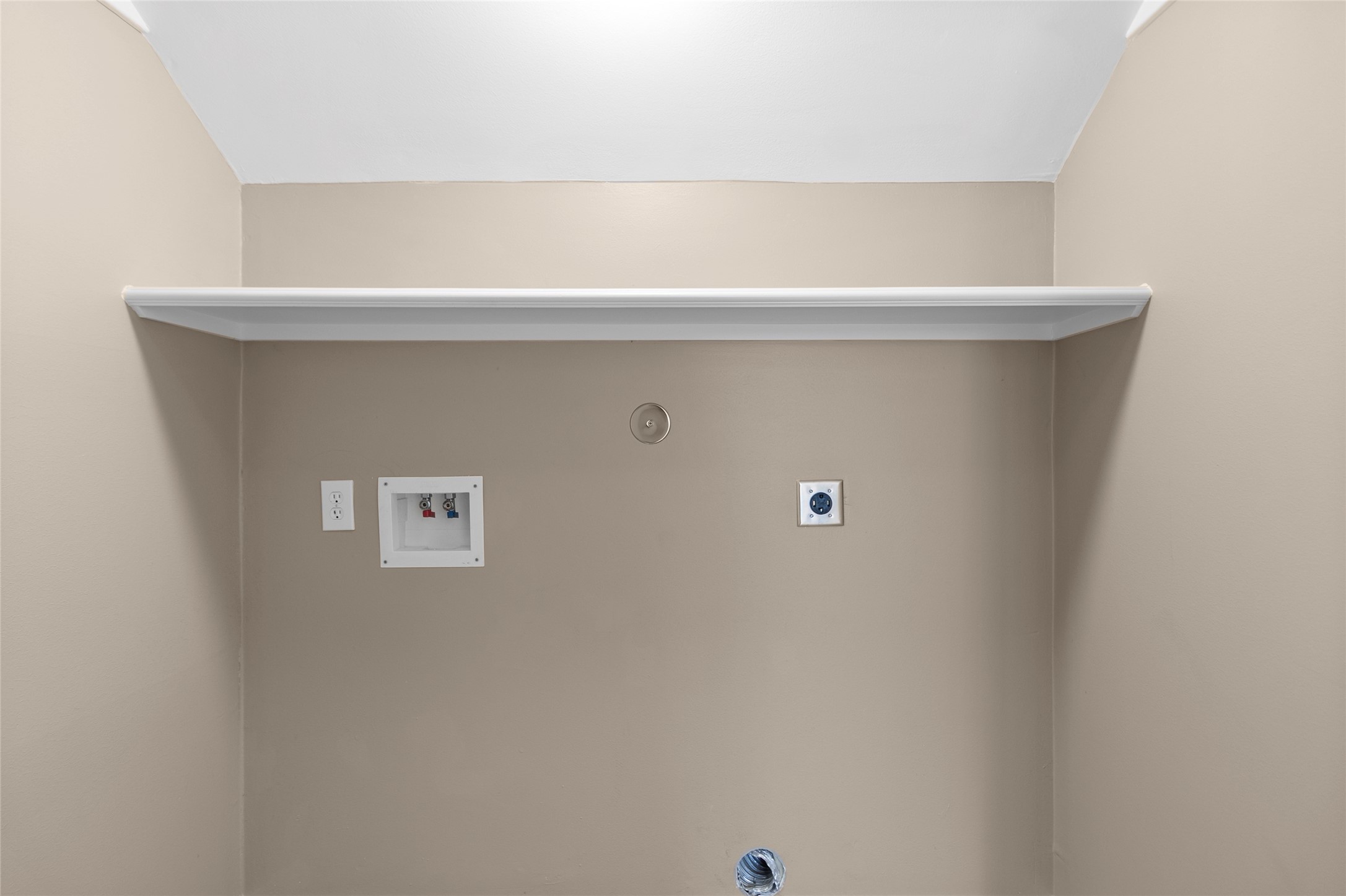 This dedicated laundry area keeps daily routines organized with extra overhead storage space for supplies, linens, and household essentials.