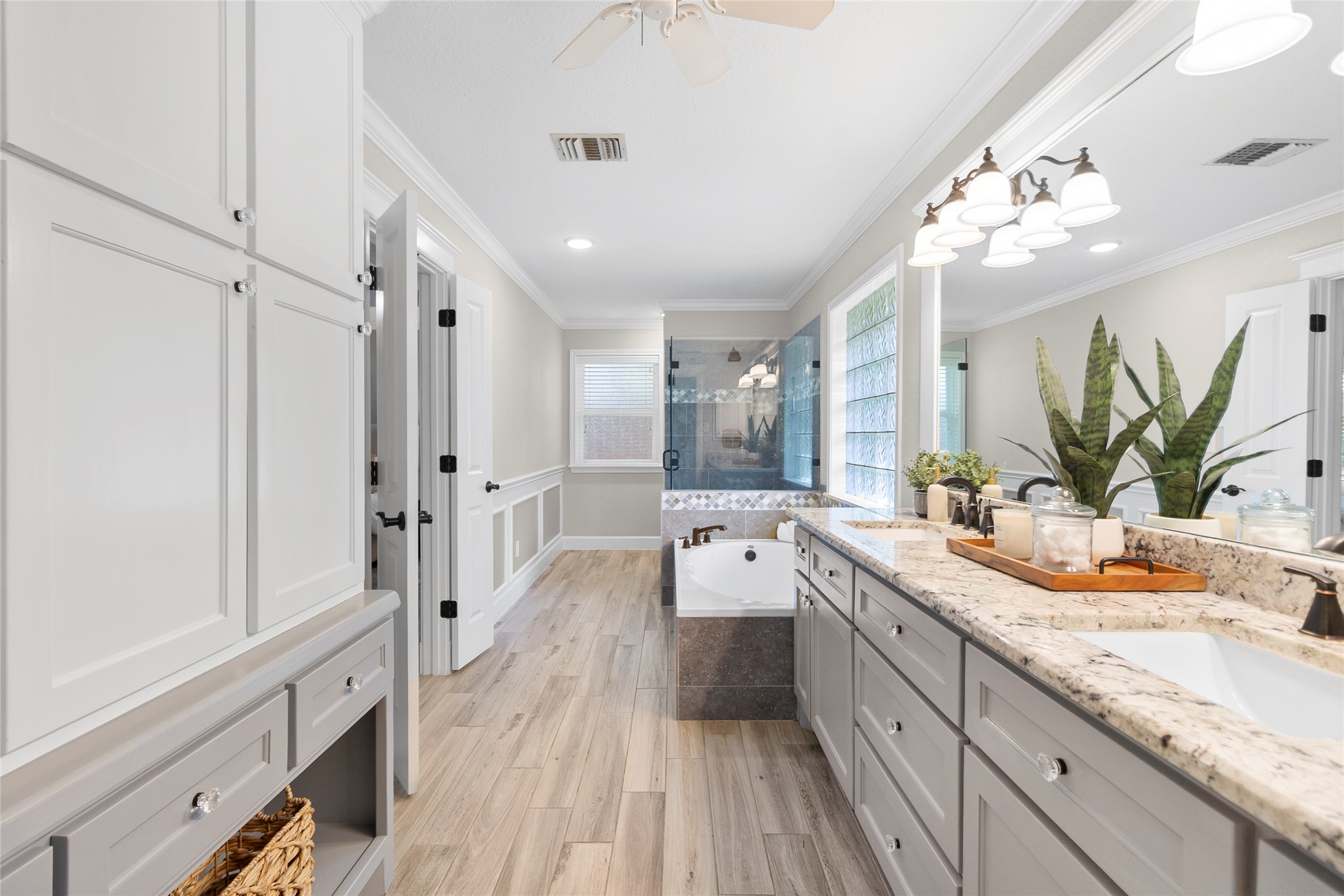 Start and end your day in a spa-inspired primary bathroom showcasing dual vanities, elegant finishes, abundant storage, and a beautifully designed soaking area.