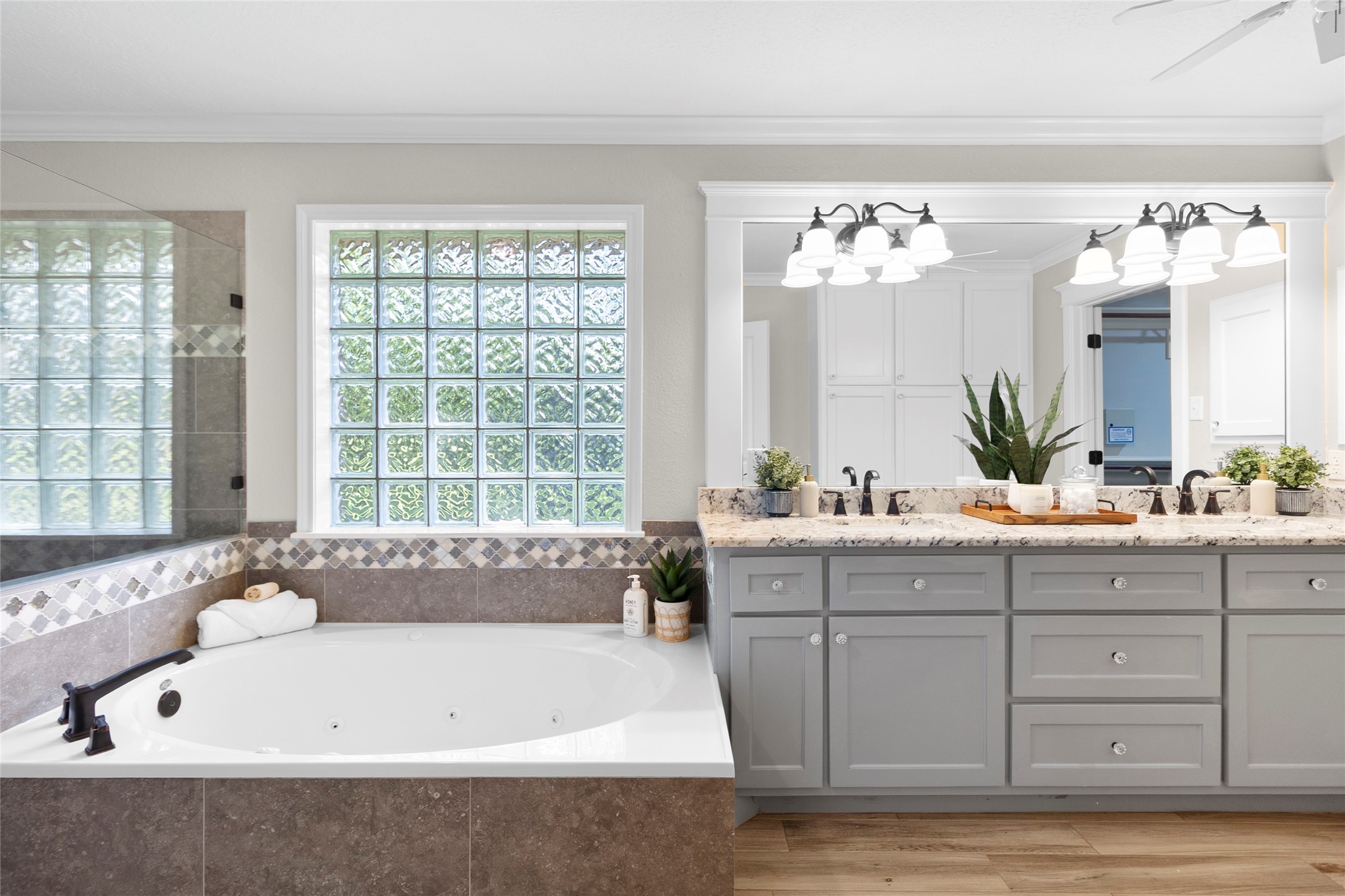 Unwind in your oversized soaking tub surrounded by designer tilework, natural light, and calming finishes that transform everyday routines into a peaceful escape.