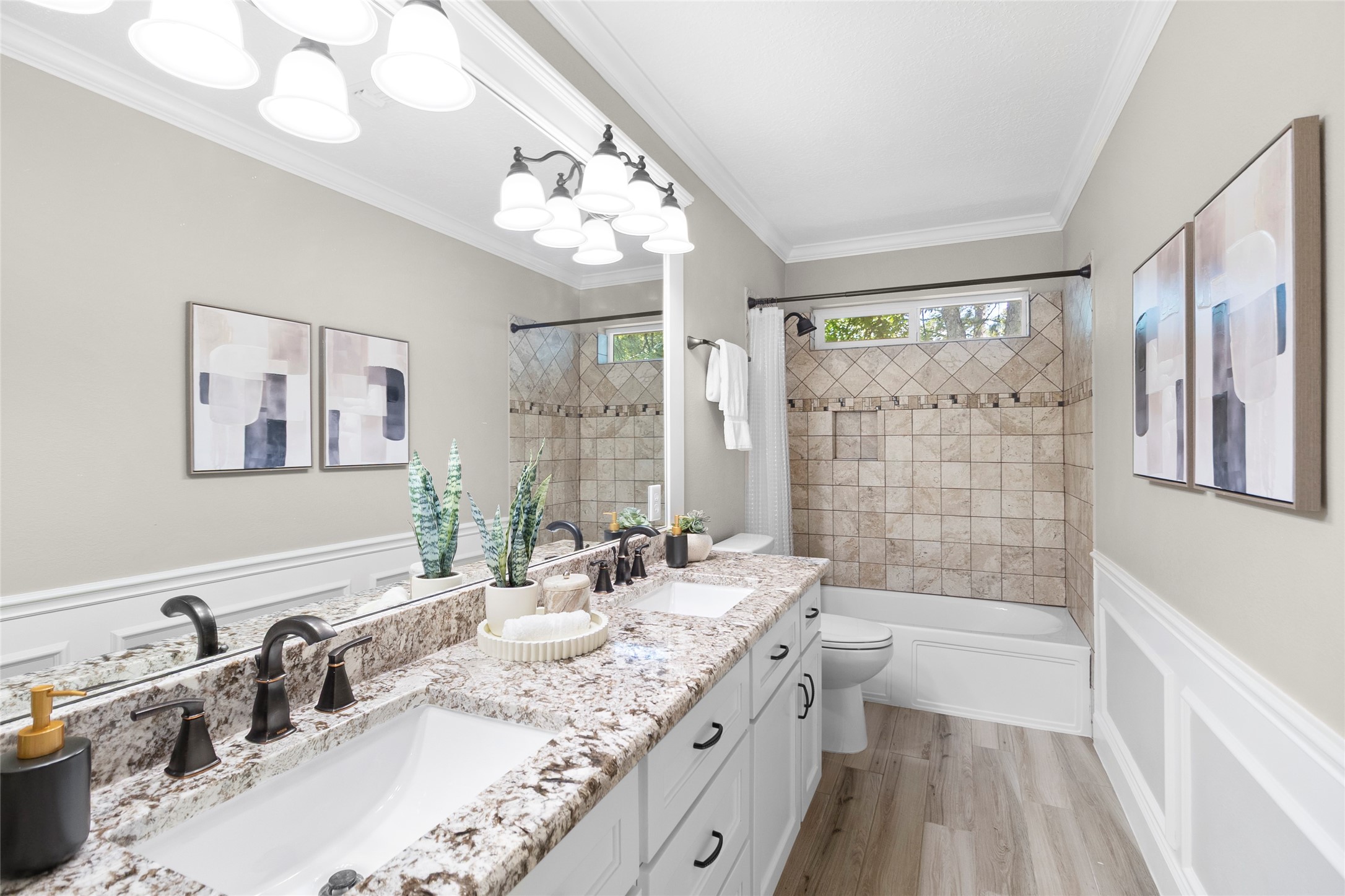 Guests and family alike will appreciate the beautifully finished secondary bathroom featuring dual sinks, granite-style counters, and timeless tilework throughout.
