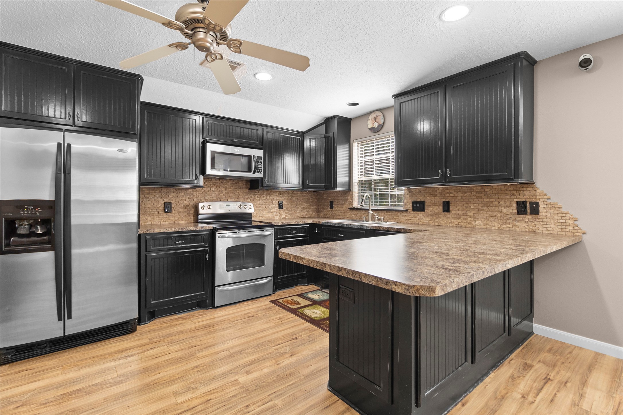 Gather around your oversized breakfast bar where casual meals, morning coffee, and entertaining guests naturally become part of everyday life.