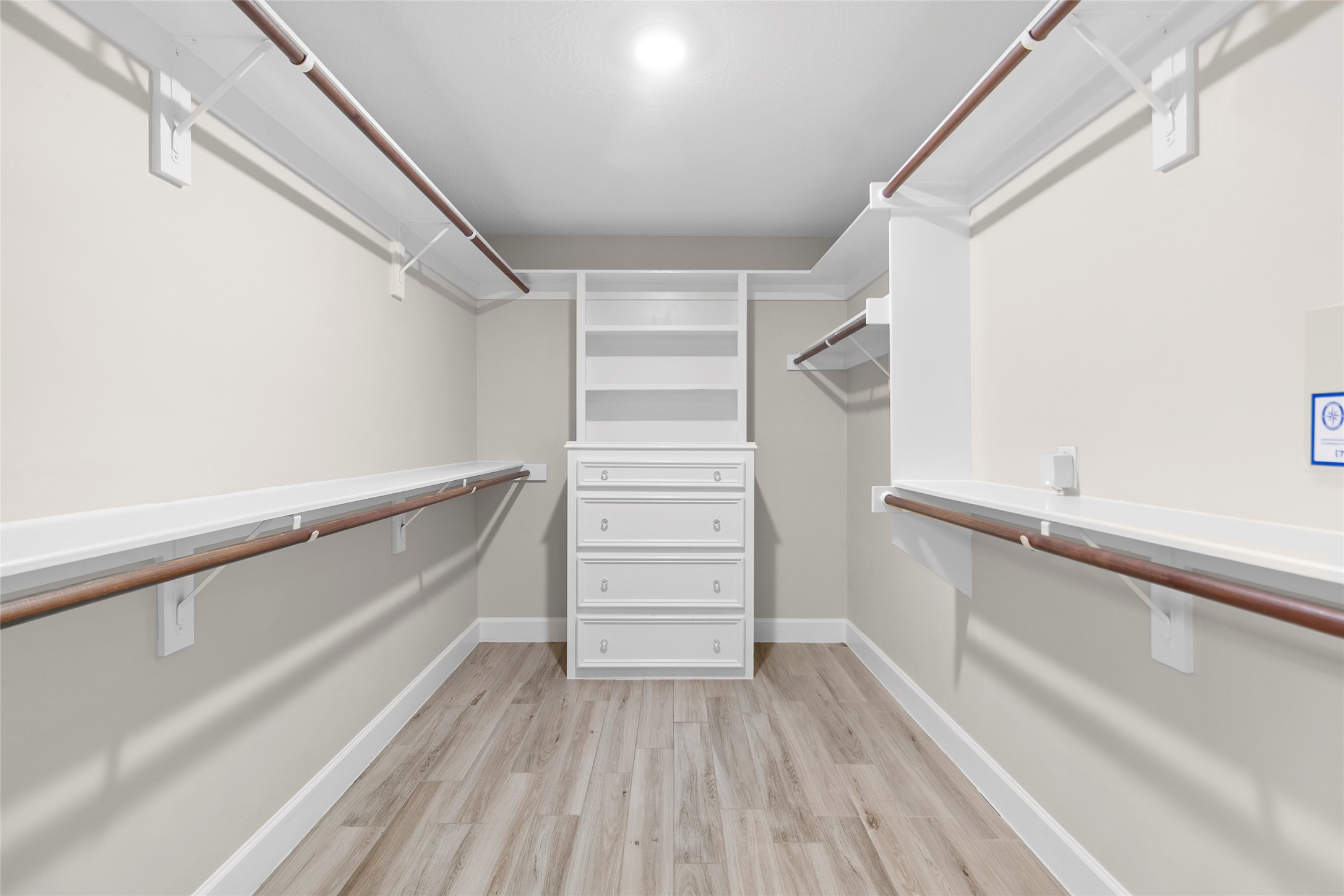 Your oversized walk-in closet delivers boutique-style organization with custom shelving, built-in drawers, and room for every season of your wardrobe.