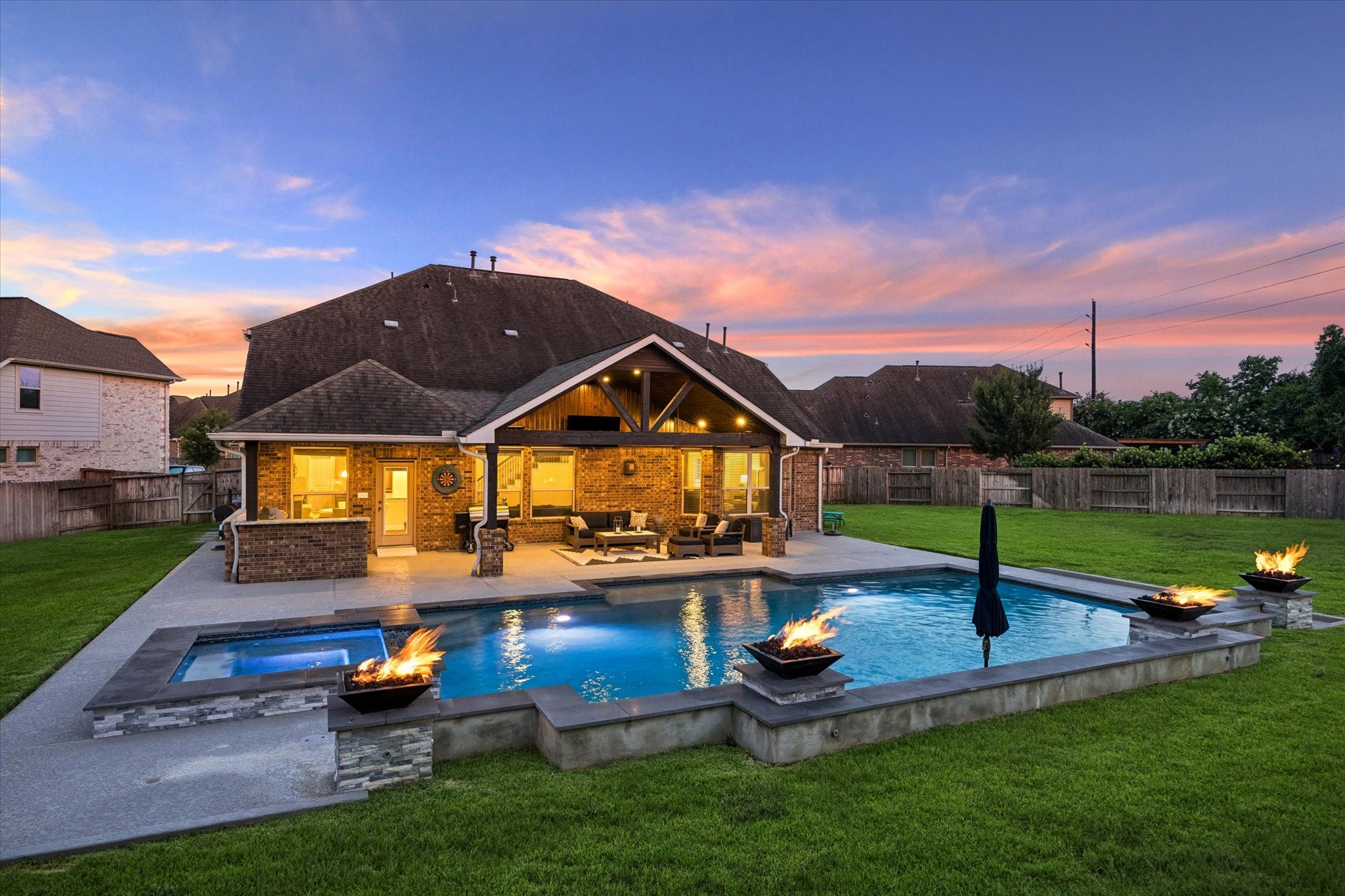 ALMOST A HALF OF AN ACRE manicured lawn provides plenty of room to play and unwind, while the privacy fencing creates a secluded atmosphere.