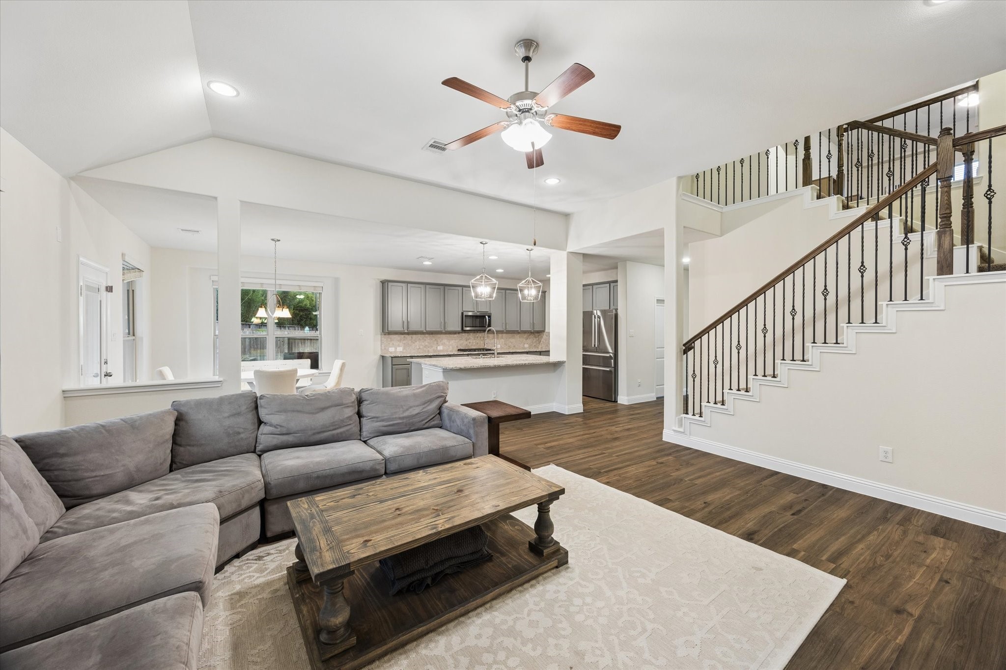 This open floorplan connects the family room, breakfast area, and kitchen - wonderful flow. A beautifully detailed staircase with wrought-iron railing adds architectural character and a sophisticated focal point to the space.