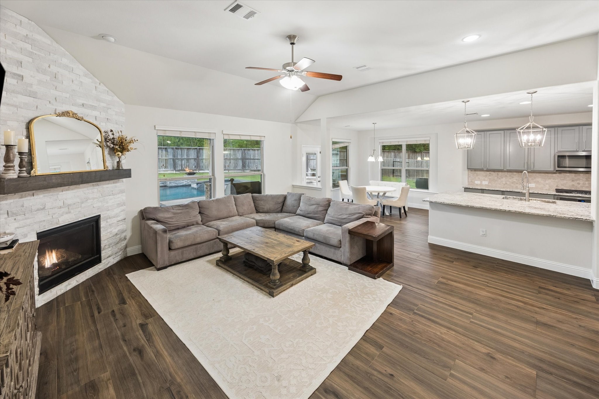 Large windows overlook the backyard and pool. All main area flooring is with luxurious wood-like tile floors.